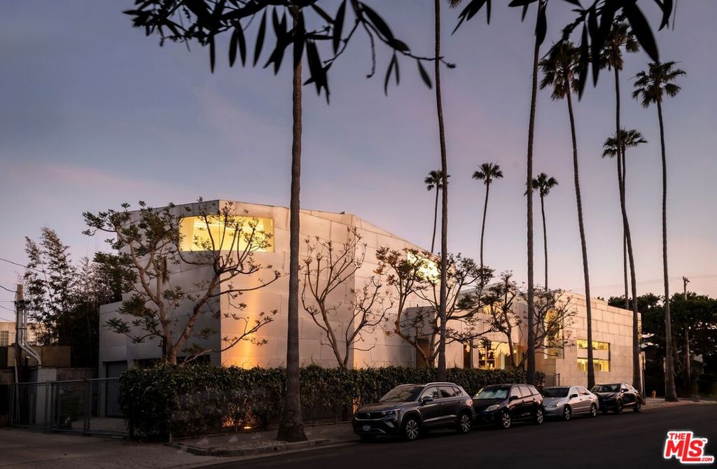 A masterwork of design and discretion, this iconic 5,300 SF structure by Godfredsen-Sigal Architects originally envisioned as the Baldessari Gallery has been transformed into a one-of-a-kind architectural residence. Wrapped in galvanized steel and tucked behind a secure facade, the home blends museum-quality construction with the warmth of curated living. Expansive gallery-like volumes with soaring ceilings and soft, indirect light create the perfect canvas for art, life, and expression. A refined entry opens into dramatic living and entertaining spaces, with multiple zones for lounging, dining, and creative work. The layout includes a sleek kitchen, three bathrooms, flexible use rooms, and garage access all grounded in a minimalist material palette and monolithic presence. Whether you're an art collector, creative visionary, or design purist, this home offers an unparalleled opportunity to live inside a piece of architecture that defies convention and invites imagination.