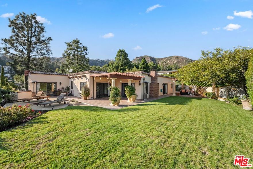 Offered for lease for the very first time, this charming hacienda-style single-level home is ideally located to capture ocean, canyon, and mountain views. Featuring three bedrooms and three bathrooms, this home offers an ideal open floor plan designed for seamless indoor-outdoor entertaining. The home features a family room and a living room with exposed wood-beams, stone fireplaces, and direct access to the outdoors. The kitchen is equipped with high end appliances, granite island and counters, and cabinetry that offers ample storage. The primary suite has access to the back patio, and it includes a spacious closet. The primary bathroom includes a spa soaking tub within a generous shower area, filled with natural light. Wood floors flow throughout most of the home. The grassy yard offers stunning views and it includes three separate patio areas, a beautiful fountain, and cozy fire pit, ideal for entertaining and enjoying the coastal life. Don't miss the opportunity to experience living in this delightful and lovely home.