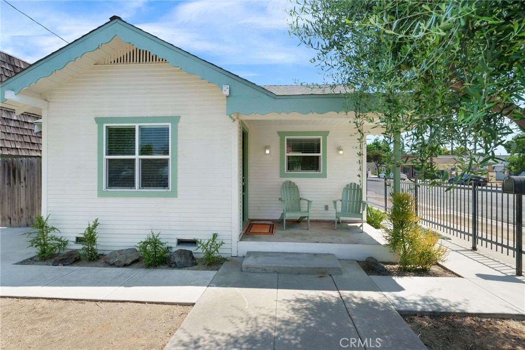 Own this adorable “California Bungalow” built in 1923 and get the benefits of original character with modern upgrades. The home sits on a corner lot with beautifully maintained olive trees and California friendly landscaping. Step onto the charming front porch to enter the living room with new flooring and natural light. The first bedroom features a ceiling fan and sliding mirror closet doors, and the second room with a window and large closet can be used as an office or bedroom. The tiled tub shower has sliding glass doors and new plumbing fixtures, with plenty of linen storage space in the hallway outside the bathroom. Kitchen boasts Maple cabinets, granite countertops, gas range & hood vent and leads directly to an enclosed porch with W/D. Water heater replaced in 2018. Your insurance will love this! Modern electrical system with 100 amp panel, new wiring throughout, copper water lines and ABS sewer lines. Dual pane windows keep the home nice and quiet inside, along with insulated walls and ceilings. Central air for AC and heat. The fenced yard provides for plenty of outdoor space, plus a private backyard BBQ area at the rear of the home. If this isn’t enough, this house comes with a converted garage! The garage has a kitchenette and bathroom that you can use as a workshop or separate office space, and has a separate gated entrance that can be connected to the main house or closed off for privacy. You can choose to use both spaces together, or separate the house and garage into two uses. The back of the property also features a custom-built wood shed with an entry on both sides, so you can either join it together or keep them separate. The home is conveniently situated between several freeways and nearby Simms Park, Downtown Bellflower, local schools and the LA County Fire Station. You may also qualify for a $20,000 homebuyer grant! Schedule a showing or stop by an open house to see the potential of this move-in ready home!