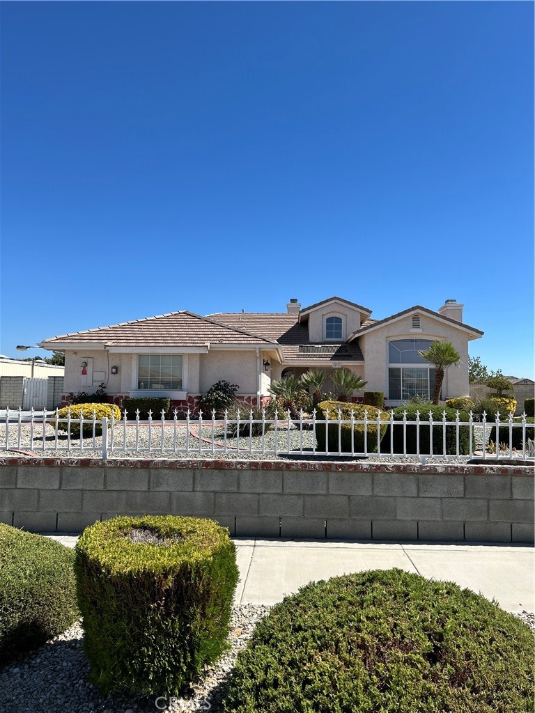 )Beautiful home in a gorgeous neighborhood. The home shows pride of ownership. Occupied by original owners. Located on a corner lot. Completely gated and fenced. The front has an electronic gate. The home boast of 4 bedrooms, and 2.5 baths. The entrance is dramatic with cathedral ceilings. . The living room has a welcoming fireplace and windows galore. The formal dining room offers a nice touch. There is a family room with a fireplace adjacent to the kitchen with an eating area in kitchen. The kitchen is spacious with plenty of cabinets, a center island, built in desk, double oven, microwave, plenty of counter space, and gas cooktop.
The primary bedroom has a sitting area, and a sliding patio door leading to a covered, tiled patio. The primary bath has dual sinks, garden tub, stall shower, toilet with a privacy door. The primary bedroom has a huge closet, which is an absolute dream. The main hall bath has dual sinks and tub/shower.
The backyard has a covered patio with tile flooring that extends almost the length of the house. The back yard has many mature fruit trees., The entire lot is manicured, with many roses and plants. Included is a payed solar system.