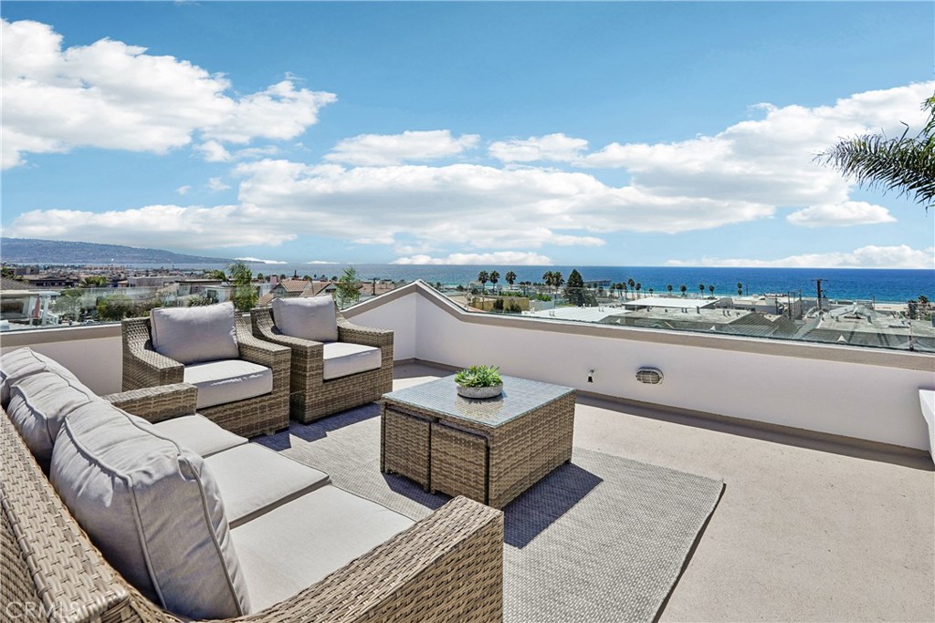 Welcome to 1550 Monterey Blvd. This is an extraordinary opportunity to own one of Hermosa Beach’s most coveted corner-lot residences, where panoramic ocean views stretch from Catalina to Malibu and the beach is just three blocks away. A Home That Captivates at Every Turn - This 2,700-square-foot Santa Barbara-style masterpiece is more than a home—it’s a sanctuary. From the moment you step inside, you’re greeted by rich European walnut hardwood floors and a layout designed to celebrate the sea. The upper level is a showstopper: expansive windows frame the ever-changing Pacific, while the open-concept living and dining areas invite you to linger over sunsets and starlit evenings. Designed for Entertaining & Everyday Joy - The chef’s kitchen is a dream, featuring stainless steel appliances, granite countertops, a walk-in pantry, and a dedicated chef’s desk for planning meals or organizing your day. A wet bar and ocean-facing balcony make hosting effortless, while the dining room offers front-row seats to golden hour. On cooler nights, gather around the fireplace under the domed skylight for a magical evening of stargazing. Retreat to Comfort & Serenity - Downstairs, the second level offers three spacious bedrooms, including a luxurious primary suite with a spa-inspired bathroom, double-sided fireplace, and a generous walk-in closet. This level also includes a second full bathroom for guests or family. On the first floor, you’ll find a versatile family room—perfect for movie nights, playdates, or quiet mornings on the patio—alongside a third full bathroom, a full laundry room, and direct access to an oversized two-car garage. The top floor features a convenient powder room, adding flexibility and comfort to the main living space. Location, Lifestyle, Legacy - Situated in the heart of Hermosa Beach, this home places you just steps from vibrant nightlife, boutique shopping, and a diverse array of dining experiences. Whether you're strolling to the sand or savoring ocean breezes from your balcony, every day feels like a vacation. Don’t Miss This Rare Gem - Homes like this are few and far between. With its unbeatable location, timeless design, and sweeping views, this property is a true crown jewel. Schedule your private showing today and prepare to fall in love.