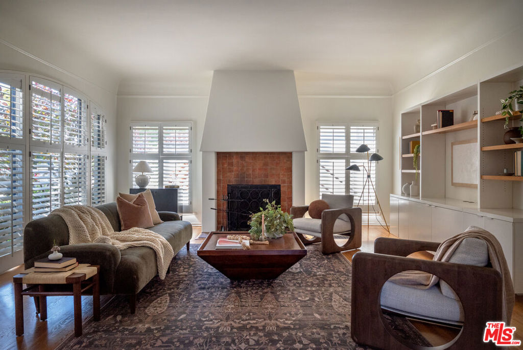 Perched on a coveted street in the Los Feliz Hills, this stunning Spanish residence blends timeless character with sophisticated modern updates. Brimming with charm and natural light, the four-bedroom plus office, two-bath home offers expansive city, mountain, and observatory views throughout. A sun-drenched living room showcases coved ceilings, a wood-burning fireplace, and beautifully preserved original hardwood floors, setting a tone of effortless refinement. The chef's kitchen features top-of-the-line appliances and captivating views that flow seamlessly to multiple outdoor living spaces overlooking the landscaped grounds. The expansive backyard is a true private retreat, featuring multiple patios for lounging and dining, a rejuvenating jacuzzi, and a large, lush garden ideal for relaxation or entertaining under the stars. Located in one of Los Feliz's most sought-after enclaves, this residence offers the perfect blend of privacy, elegance, and proximity to the neighborhood's celebrated restaurants, hiking trails, and cultural landmarks.