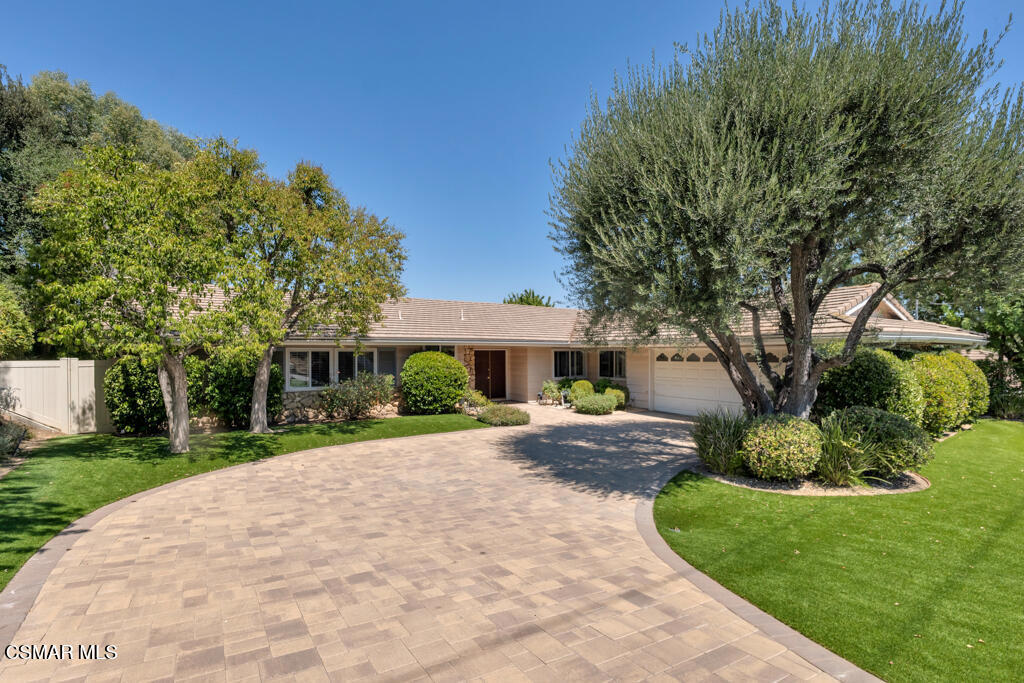 SINGLE-story VIEW home in the coveted Greater Mulwood neighborhood of Calabasas! Nestled on a spacious 12,200 Sq Ft lot with wide-open tree-top and hillside views, this wonderful 3-bedroom, 3-bathroom home offers BRIGHT interiors, elegant living spaces, and a private backyard perfect for outdoor entertaining. Fantastic curb appeal welcomes you with lush landscaping and a HANDSOME curved paver-stone driveway framed by mature trees and wood exterior trims. A covered front porch sets the tone for what awaits inside--step through the charming front door and into a sunlit interior where REAL wood flooring and abundant natural light greet you at every turn.The Living Room is filled with natural warmth and sunshine from large sliding glass doors that lead to the backyard, while a charming brick-surfaced fireplace anchors the space for cozy evenings and casual gatherings. The adjacent Formal Dining Room features tall windows with plantation shutters, continued real wood flooring, and tranquil views to the front yard.The Family Room--ideal for hosting or relaxing--boasts a continuation of wood flooring, sliding doors to the backyard, and a stylish wet bar complete with granite countertops.A spacious Kitchen sits at the heart of the home and has been thoughtfully upgraded with bullnose granite countertops, an abundance of cabinetry, and top-of-the-line appliances include dual Whirlpool ovens, a 4-burner KitchenAid gas cooktop, a Bosch dishwasher, and a built-in Samsung refrigerator.The bright Kitchen Eating Area enjoys a built-in desk, large windows with plantation shutters, and direct access to the upgraded Laundry Room which features ceramic tile flooring, linen cabinetry, and a MASSIVE walk-in pantry with pull-out shelving.Two Secondary Bedrooms offer comfortable guest/family living space and are served by the hall bath, which has a granite-topped vanity and a tile-walled stall shower.The Primary Bedroom is a spacious sanctuary filled with natural light and offers sliding glass doors to the backyard VIEWS, a ceiling fan, and THREE closets. Its en-suite Primary Bathroom is one-of-a-kind, showcasing charming vintage-style ceramic tile across the walls, floors, AND ceiling, a sprawling dual-sink vanity with center makeup station, and a walk-in jetted soaking tub with door entry.The Backyard is a PRIVATE outdoor VIEW retreat designed to capture the best of Southern California's year-round climate. A generous concrete patio provides plenty of space for lounging, dining, or entertaining, while attractive artificial lawns and mature landscaping frame the INCREDIBLE 180 tree-top and hillside views beyond.Located in the highly desirable Greater Mulwood neighborhood, residents enjoy access to the COVETED & award-winning Las Virgenes Unified School District along with CLOSE proximity to Gelson's, Calabasas Commons, local parks, hiking trails, and the 101 Freeway for smooth commuting. With access to acclaimed Las Virgenes schools and just minutes from shopping, dining, and scenic hiking trails--this is Calabasas living at its finest!