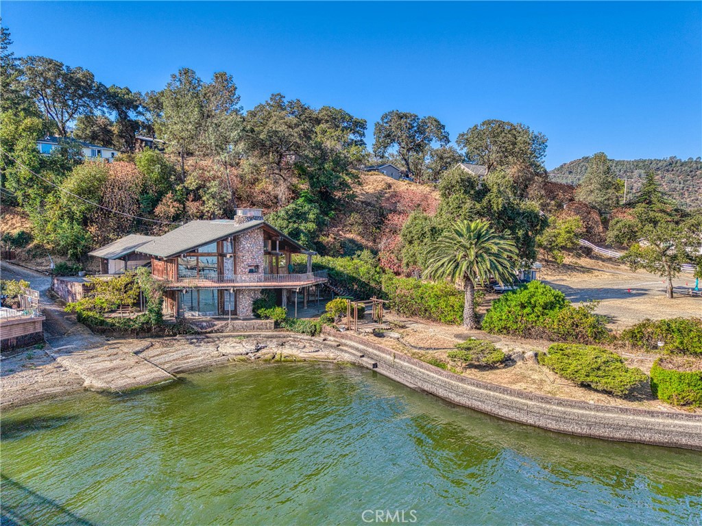 Architectural Lakefront Treasure on a Private Peninsula !!!
This one-of-a-kind lakefront home is an architectural gem, offering soaring vaulted ceilings with exposed wood beams, walls of windows, and multiple skylights that fill the home with natural light. A dramatic rock fireplace anchors both the main living area and the spacious downstairs family room, creating warmth and character throughout.
With 4 bedrooms, 3 baths and a versatile loft area this home offers plenty of room for family, guests, or vacation income potential. The lower level family room provides ample space for games, yoga, or a home theater—tailored to suit your lifestyle. A generous storage area doubles as a workshop, ideal for hobbies, tools, or creative projects.
Outdoors, a wraparound deck is perfect for entertaining, while the property itself rest on approx. ¾ acre of natural landscape on its own private peninsula. The setting provides privacy , beauty and plenty of elbow room , with expansive usable lake frontage, multi-car carport, shared boat ramp, and a private pier.
Definitely not a cookie-cutter house, this property exudes aesthetic appeal and structural charm. With vision and care, it can be restored and maintained to showcase its true architectural value. A rare opportunity for large families, retreat seekers, or investors looking for a unique vacation rental !!!
“Don’t miss your chance to own this rare lakefront retreat where privacy, character, and endless possibilities come together.”
( Age, permits, lot size not verified by agent tax record show 3BD’S)