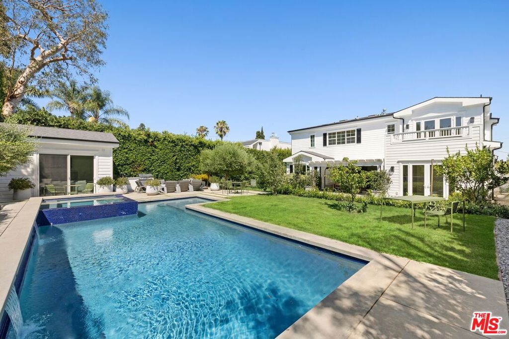 Discover this stunning 6-bedroom, 6.5-bathroom Traditional masterpiece, offering over 5,100 square feet of meticulously designed living space. Crafted to perfection, this home captures the essence of California's indoor-outdoor living with a seamless blend of elegance and functionality. At its heart lies a gourmet Chef's kitchen, centered around an oversized island, that flows effortlessly into a tranquil family room. Expansive bi-fold doors open to a covered patio with an inviting outdoor dining area, cozy firepit lounge, spacious pool house with its own bedroom and ensuite bath, and a breathtaking pool and spa. The main floor is an entertainer's dream, featuring expansive formal living and dining rooms, complete with a butler's pantry and wet bar. A private guest suite with an ensuite bath, a dedicated office, and a grand foyer with a striking staircase enhance the home's sophisticated appeal. The second floor unveils a luxurious master retreat, boasting 10-foot ceilings, a spa-like master bath with a soaking tub and glass-encased shower, and a custom-designed wardrobe. Every detail has been carefully curated to create a residence that epitomizes luxury and comfort. Mature and lush landscaping surrounds the property providing a resort-style ambiance, ensuring ultimate privacy and tranquility. Please note: Some photographs have been virtually staged to showcase the potential of the property.