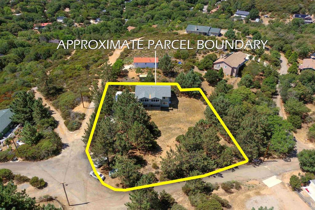TURNKEY and remodeled. Ideal for large family or inlaws for UPSTAIRS features 2BR/2BA and DOWNSTAIRS has 1BR/1BA with 2 pvt entries and covered front porch. Enter through electric gate to fenced and usable .68 of an acre enhanced by RV parking, loads of mature PINE trees, owned propane tank and room for animals, equipment and desert toys. You will appreciate the spacious great room with forever views of the mountains and trees, luxuary vinyl wood floors, attic fan, kitchen with newer self/closing cabinets, granite counters, breakfast bar, stainless steel upgraded appliances and french door to enclosed porch also featuring dual paned windows. The master suite has quality carpeted floors, lots of closet space, sitting/office area that opens to front porch and attractive bath with tiled tub/shower combo. The second bedroom has a walk in closet and alcove for office desk space and quest full bath. The downstairs unit features master bedroom with bath, laundry room (which was a previous kitchen), living and dining rooms and door to private storage room. This property is a rare find and well worth your viewing!!!