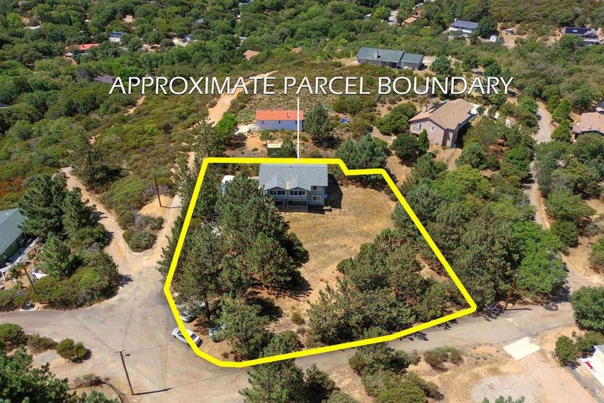 TURNKEY and remodeled. Ideal for large family or inlaws for UPSTAIRS features 2BR/2BA and DOWNSTAIRS has 1BR/1BA with 2 pvt entries and covered front porch. Enter through electric gate to fenced and usable .68 of an acre enhanced by RV parking, loads of mature PINE trees, owned propane tank and room for animals, equipment and desert toys. You will appreciate the spacious great room with forever views of the mountains and trees, luxuary vinyl wood floors, attic fan, kitchen with newer self/closing cabinets, granite counters, breakfast bar, stainless steel upgraded appliances and french door to enclosed porch also featuring dual paned windows. The master suite has quality carpeted floors, lots of closet space, sitting/office area that opens to front porch and attractive bath with tiled tub/shower combo. The second bedroom has a walk in closet and alcove for office desk space and quest full bath. The downstairs unit features master bedroom with bath, laundry room (which was a previous kitchen), living and dining rooms and door to private storage room. This property is a rare find and well worth your viewing!!!