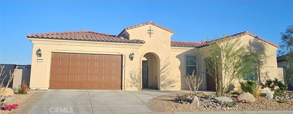 Welcome to a Journey floorplan at Del Webb Rancho Mirage that stands apart from the rest. Situated on an expansive, professionally landscaped lot with large side yards, this home offers breathtaking views that will captivate you, especially during the stunning desert sunrises. After entering through a private courtyard, upon opening the front door you'll immediately notice the high-end upgrades, including composite stone flooring throughout the home. The great room is an entertainer's dream, featuring wall-to-wall sliding doors that create a seamless transition between indoor and outdoor living. The chef's kitchen boasts KitchenAid appliances, an upgraded cabinet package, large island with an eating bar, walk-in pantry and dining area that looks out to your own 3 hole putting green. The adjacent bonus room, currently a music room, offers flexible space that can be adapted to fit your needs. The owner's suite, with private access to the patio, has an ensuite bath that features dual vanities and a spacious walk-in shower with a built-in bench. The large walk-in closet has been thoughtfully customized with extra hanging space, drawers, cupboards, and shoe racks. The back bedroom, offers a private entry, full bath, ceiling fan, and walk-in closet. The hall bath, conveniently located near the third bedroom, includes a custom-tiled shower, a vanity with a gold vessel sink, and a designer toilet. Owned solar panels help you stay cool in the summer without high energy. The laundry room is equipped with a utility sink and built-in cabinets, and the separate golf cart garage works great for additional storage. The Outlook is the gathering spot that offers endless activities to enhance your lifestyle. Take advantage of two pools, a hot tub,18 hole putting course, bocce ball, tennis & pickleball courts The clubhouse also features a bar area for socializing, ballroom, billiards, golf simulator, and a card room. Take advantage of the well equipped gym and studio that offers a variety of classes. You’ve worked hard—it’s time to enjoy the low-maintenance, amenity-rich lifestyle you deserve in the heart of the Coachella Valley. Opportunities like this don’t last.