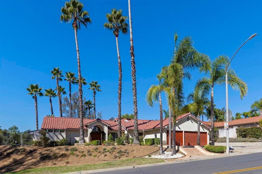 Ranch-Style Single-Story Home on Corner Lot! Escondido home offers a unique and spacious layout, with a bedroom suite in each wing for ultimate privacy. Master suite features french doors that lead out to the patio. Master bath has natural light with an inviting oversized tub, walk in closet, dressing table, and separate toilet room.  The open floor plan creates a welcoming and airy atmosphere, perfect for both relaxation and entertaining. The home features a three-car garage and sits on a bi-level lot—allowing for a large upper yard that overlooks the lower level, providing a sense of space and tranquility. Perched at the top corner of the street to take full advantage of the surrounding views, making it the perfect retreat.