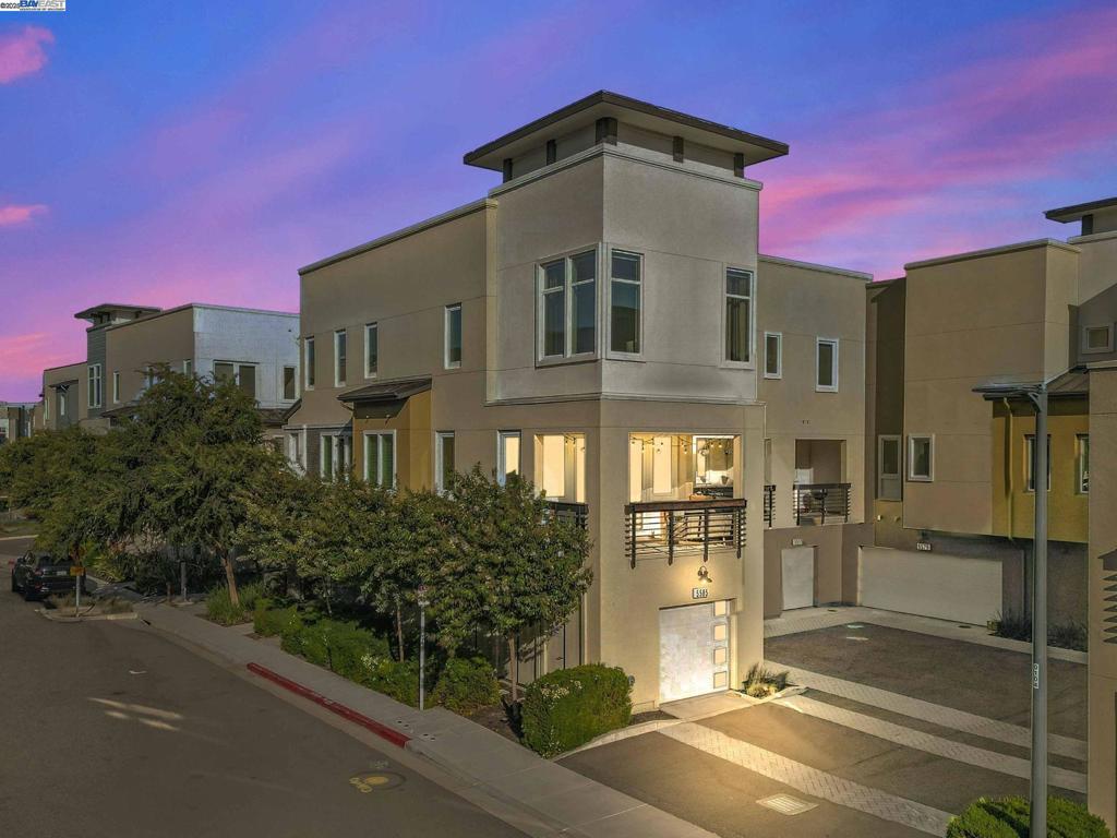 Welcome to this stunning corner-unit, tri-level townhome in the desirable Union at Boulevard community of Dublin. This sought-after Plan 2 residence offers 2 bedrooms, 2.5 bathrooms, and 1,526 square feet of thoughtfully designed living space. Enjoy an open-concept layout with luxury vinyl plank flooring, soaring ceilings, oversized windows, and abundant natural light. The gourmet kitchen features a large center island, upgraded quartz countertops, a striking antique mirrored glass backsplash, and stainless steel appliances—perfect for everyday living and entertaining. Relax in the luxurious primary suite with dual sinks, a frameless glass shower, and a spacious walk-in closet. The second bedroom includes its own private bath. Additional highlights: pre-wired 7.1 surround sound with built-in ceiling speakers, whole-house water filtration system, Nest thermostat, built-in wall safe, oversized 2-car tandem garage with Tesla charger wiring, and solar-ready. Residents enjoy access to a resort-style recreation center, pool, fitness center, parks, and more. Walk to BART, Whole Foods, shopping, dining, and enjoy easy freeway access.