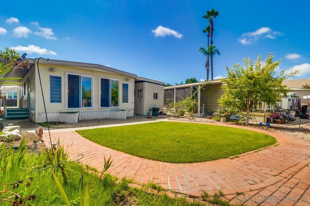 **Location & View** Welcome to this inviting manufactured home located in the highly sought-after area of San Diego. This 2 Bed-2 Bath (1060 sq/ft) home is ready to make your own. The home includes; large primary bedroom, washer/dryer, refrigerator, microwave, detached shed, and 2 carport parking spaces. The spacious backyard has a Tecolote Canyon view, mature fruit trees: lemon, pomegranate, etc. Offering easy access to major freeways, this home makes commuting easy while providing a peaceful retreat in a vibrant community. The Linda Vista Village community is centrally located, near shopping, downtown, beaches, Balboa Park and more. Association amenities include: pool, spa, clubhouse, game room. Space rent includes water/sewer and trash.