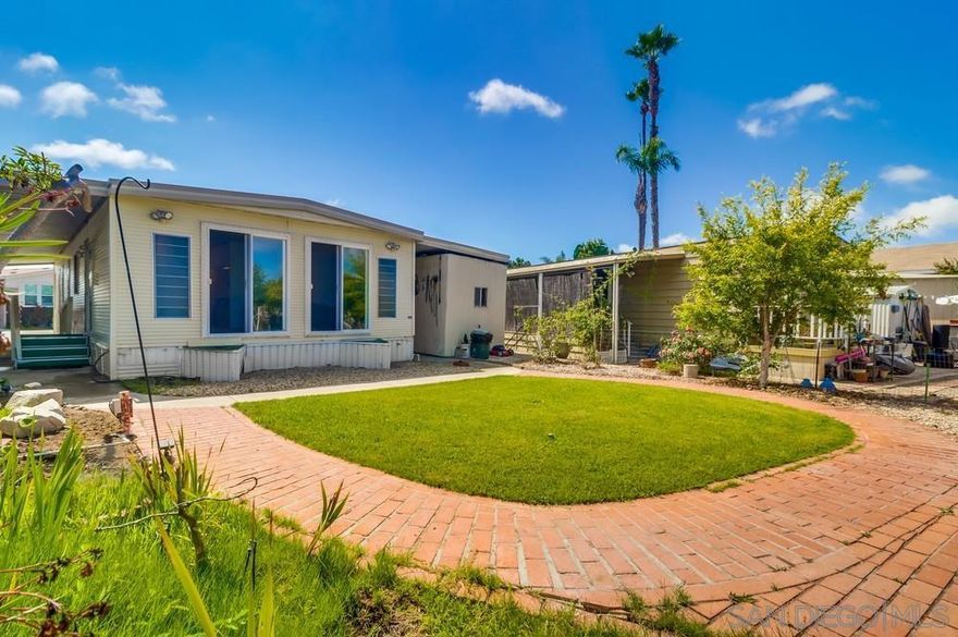 **Location & View** Welcome to this inviting manufactured home located in the highly sought-after area of San Diego. This 2 Bed-2 Bath (1060 sq/ft) home is ready to make your own. The home includes; large primary bedroom, washer/dryer, refrigerator, microwave, detached shed, and 2 carport parking spaces. The spacious backyard has a Tecolote Canyon view, mature fruit trees: lemon, pomegranate, etc. Offering easy access to major freeways, this home makes commuting easy while providing a peaceful retreat in a vibrant community.  The Linda Vista Village community is centrally located, near shopping, downtown, beaches, Balboa Park and more. Association amenities include: pool, spa, clubhouse, game room. Space rent includes water/sewer and trash.