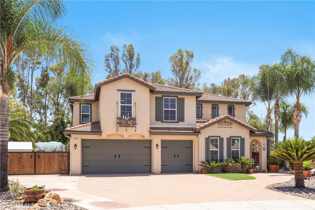 Welcome to this stunning former model home located at the end of a quiet cul-de-sac on nearly half an acre—one of the largest lots in the neighborhood. This spacious 5-bedroom, 3-bathroom home includes a convenient downstairs bedroom and full bath, ideal for multi-generational living or overnight guests. Spacious and bright with soaring cathedral ceilings in the living and great rooms, creating an open and airy feel, while custom wood accent walls and designer paint add a warm, stylish touch throughout the home. The entertainer’s kitchen features granite countertops, stainless steel appliances, upgraded cabinetry, a large center island with breakfast bar, and a walk-in pantry, all seamlessly connected to the great room, which includes custom stonework and rough hewn wood mantle at the fireplace, a media niche for the TV and whole house audio system. Adjacent to the kitchen is a built-in coffee nook and next to the great room is a built in wine bar. Window coverings include wood blinds, some plantation shutters, and electric blinds for convenience. Upstairs, the expansive primary suite offers a private tiled deck overlooking the backyard with west-facing views towards the Santa Rosa plateau, a jetted spa tub, separate shower, dual vanities, and a generous walk-in closet. Three additional bedrooms and another full bathroom upstairs provide plenty of space for family and guests. Great features such as tile flooring downstairs and in the entry, plush carpet upstairs, dual A/C units for zoned climate control, recessed lighting and more. This property also includes a 220V outlet and insulated doors in the garage, a reverse osmosis water filtration system at the kitchen sink, and a low-volume sprinkler system for efficient irrigation. The expansive backyard is a private oasis featuring a covered patio, barbecue area, garden shed on a concrete pad, and dozens of mature palms—including sego, queen, and canary island varieties. Backs to a beautifully wooded Riparian Zone that's a peaceful buffer between neighbors. Gated RV parking and storage shed adjacent to the garage. Energy-efficient solar panels help keep electric bills low, and with property taxes close to 1.1%, this home offers exceptional value. Fantastic south Wildomar location that's close to some great restaurants, Baron's Market and other shopping, easy access to the freeway, close to schools, medical facilities and just a short drive to Murrieta and Temecula.