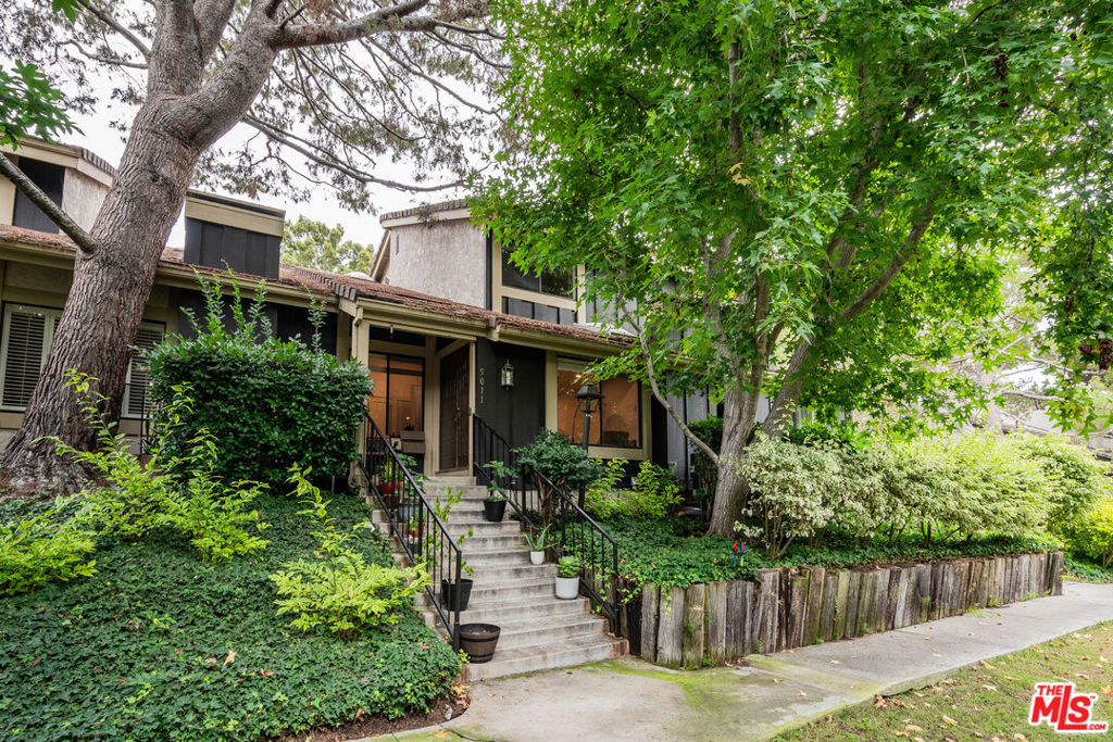 Seamlessly renovated and rare in design, this townhome in the resort-like Raintree community lives like a single-family home with private direct access and a spacious, flexible floor plan. Offering 4 bedrooms, 3 bathrooms, and approximately 1,837 SF of living space, this residence is part of a historic property that was once the MGM backlot, now a community where you can stroll along tree-lined walking trails and a tranquil lake - blending a unique sense of history with natural beauty. A grand entry leads to the living room with soaring vaulted ceilings, exposed beams, and an ebony-tiled fireplace. The chef's kitchen showcases quartz countertops, handmade Moroccan tile backsplash, shaker cabinetry, and high-end appliances, all anchored by a central peninsula. The formal dining room flows to a den/sitting area, creating the perfect setting for both everyday living and entertaining. Upstairs offers three generously sized bedrooms and two beautifully renovated baths, while the main level includes a rare fourth bedroom with full bath - ideal for guests or a home office. Direct garage access completes the convenience of single-family living. Surrounded by mature trees, serene walking paths, and a tranquil lake, Raintree provides 24-hour guard-gated security and resort-style amenities, including a pool, tennis courts, and a clubhouse. Just minutes from downtown Culver City, residents enjoy proximity to parks, hiking, studios, shopping, and some of the best dining in Los Angeles.