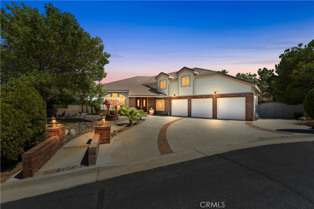 Welcome to The California Chateu Community! Nestled in a private cul-de-sac within one of West Palmdale's most desirable neighborhoods, this stunning residence offers the perfect balance of elegance, comfort, and entertainment. The home's exterior is highlighted by beautiful custom brickwork, giving it exceptional curb appeal. As you step inside, a grand staircase sets the tone for the spacious and inviting interior. The open-concept downstairs features a formal dining room, a cozy family room, and a chef's kitchen with abundant cabinetry—ideal for both everyday living and entertaining. The generously sized primary suite includes a private balcony, a spa-like bathroom with dual sinks, a soaking tub, separate shower, and plenty of space for true relaxation. Secondary bedrooms are equally spacious, offering comfort and flexibility for family or guests. Step outside to your own private oasis: an amazing backyard with a sparkling pool, perfect for summer gatherings and California living at its finest. This is a rare opportunity to own a home in the coveted California Chateu community of Palmdale—private, peaceful, and designed for the lifestyle you deserve.
