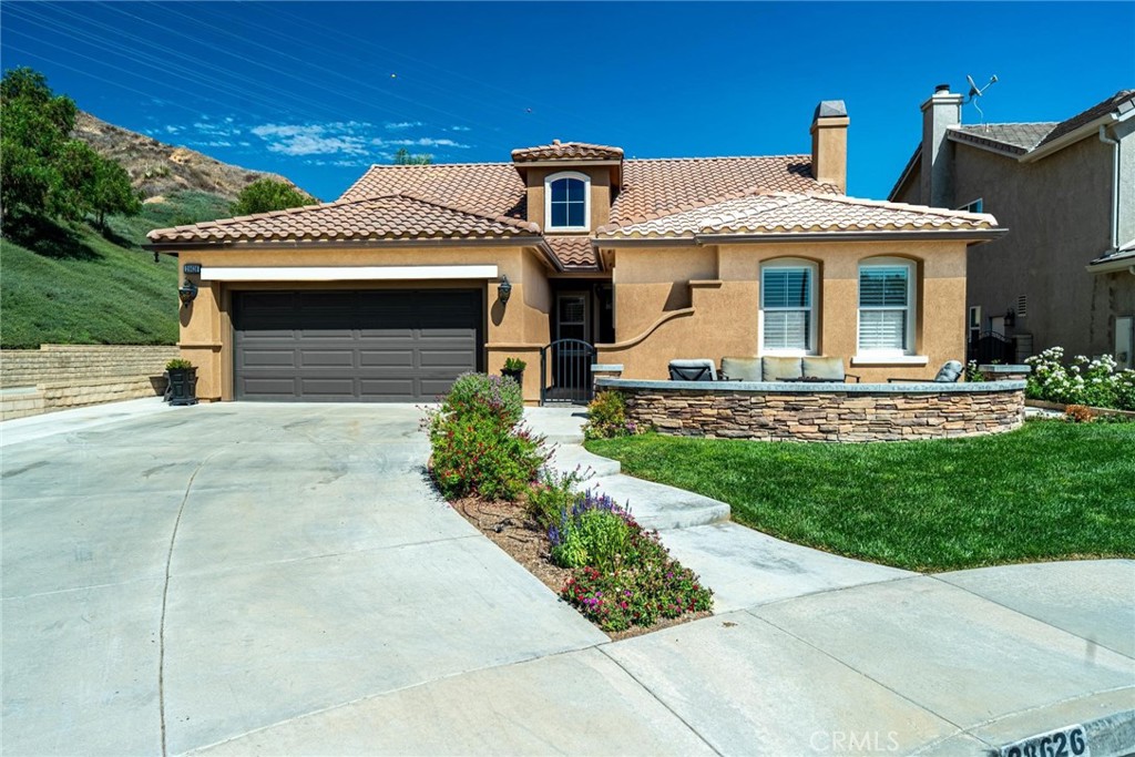 Can’t find a large single story? This popular floorplan has the primary suite PLUS two more bedrooms downstairs! Full bedroom and bathroom upstairs plus a spacious loft. Terric versatility and rarely for sale. This absolutely gorgeous pool home is located at the end of the cul-de-sac. The kitchen is breathtaking. It was remodeled in 2024 with outstanding meticulous finishes. Greige custom cabinetry with 4 ft doors, black hardware, all soft close drawers, island with built-in microwave and pull-out cabinets, quartz countertops, ceramic 3x12 horizontal backsplash and Café appliances. Custom pantry with pull-out drawers. Laminate “white oak” looking floors throughout with 6-inch baseboards. Family room fireplace was redone with new custom doors and tiled fireplace. The primary suite bathroom was also remodeled in 2024 with a custom dual vanity, quartz countertops and a beautiful walk-in shower featuring hexagon white tile flooring and 3x12 tile walls. Primary suite added French doors off the back leading to the covered patio. The other two bedrooms downstairs are also good-sized and share another bathroom which has been remodeled with a custom vanity, mirror and lighting. Linen closet has been added for additional storage right outside the bathroom. Formal living room has a fireplace with custom doors, newer mantel and trendy sconces. Upstairs loft is large and would make a great game room or second family room. Bedroom upstairs is currently set up as an office but has a closet which makes it the 4th bedroom in the house. Entertainers’ backyard! Outdoor island with BBQ, covered patio, pool and spa, and turf! Extra-long and wide driveway with a 3-car garage. No Mello Roos. This home is a 10!!