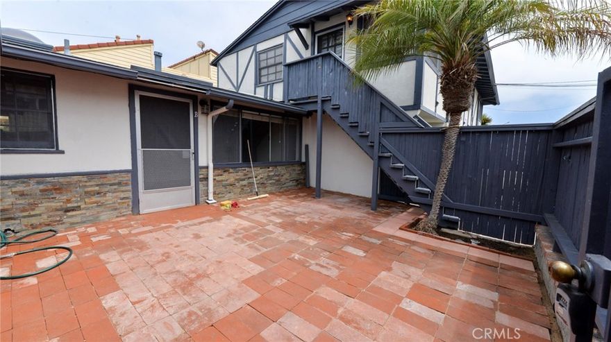 Welcome to your coastal retreat in the heart of San Clemente! This inviting one-bedroom, one-bathroom apartment home blends timeless character with modern comforts, offering a truly special living experience just steps from the beach. From the moment you enter, you’ll be charmed by the rustic elegance of brick paver flooring, tall wood-beamed ceilings, and an abundance of natural light that pours in through a skylight in the open-concept kitchen. Whether you're cooking, relaxing, or entertaining, the airy layout creates a warm and welcoming atmosphere. Thoughtfully designed for everyday living, this lower-level unit features generous closet space and built-in storage to keep your home effortlessly organized. The bedroom includes a wall A/C unit, while a new double-sided heater ensures year-round comfort. Step outside to enjoy your own extra-large private front patio, fully enclosed for privacy—perfect for lounging, dining, or soaking up the sun in your own tranquil space. Additional amenities include one covered off-street parking space with cabinet storage, a shared on-site laundry room, and an unbeatable location that combines the serenity of a private residence with the convenience of walkable coastal living. Come experience the charm, comfort, and easy beachside lifestyle this unique San Clemente apartment has to offer!