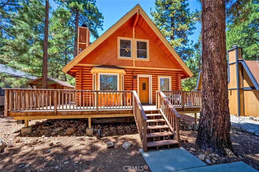RARE find Erwin Lake Area and now it can be yours. This Full Log Cabin Home really delivers!! Experience the easy going vibe of rural living. Nestled in the peaceful and desirable Mitchell side of Highway 38. Convenient to all of Big Bear’s many attractions including ski slopes, Big Bear Lake, The Village Shopping and Restaurants, National Forest Hiking Trails, Off Road Trails, easy highway access and much more. This cozy full log cabin home is really Something Special offering interior features that include a spacious downstairs living area that includes log interior walls, forced air heating, wood burning fireplace, full kitchen with natural gas cooking a breakfast bar countertop and a separate dining room area. Rounding out the downstairs is a spacious bedroom, full bathroom and inside laundry room. The 2nd story living space features two very large bedrooms and a shared ¾ bathroom with a walk-in shower. Exterior features include superior curb appeal, dual pane windows, wrap around front porch deck, concrete parking space for at least two cars, 8x12 storage shed, large frontage area for additional parking. The backyard features a roomy covered patio that is very relaxing and tranquil, the backyard is also fully fenced offering security and privacy. This home can be utilized for many different byer needs including primary residence, second home, vacation or fulltime rental income too.