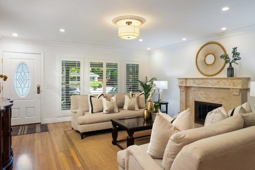A sophisticated example of one-level living- from the soaring vaulted ceilings, skylights, plus rich detail with elevated design features through out. Situated on a sought after tree-lined street in the sunny Woodside Plaza Neighborhood of Redwood City, known for it's easy to navigate streets, proximity to dining, shopping, commute routes, parks, and a that "neighborly" feel so many seek out. Charming brick accents and the perfect front porch for enjoying morning coffee even on the few rainy days. Inside, experience the warm hardwood floors, with a formal living room centered around a gas fireplace welcoming you to experience the home's versatile floorplan revealing itself, each room more impressive than the next. The dining room is flanked by dramatic columns. Radiating from the core of the home, is a bedroom hall with two large sun-filled bedrooms, making use of a hall bath with tile stall shower. The kitchen is flooded with natural light via large skylight & has a gas range, plus unload groceries easily with the convenience of the attached garage. Off the kitchen is the grand family room with soaring ceiling dual skylights, interior laundry, and a half bath. A spacious primary suite has ample closets, an upgraded bath, and is open to the large back deck and park-like yard.