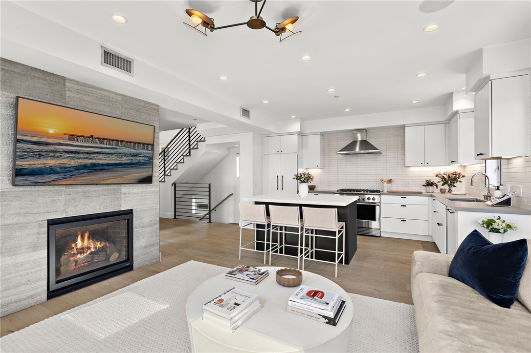 Experience laid-back luxury in this modern coastal residence originally crafted by SAILHOUSE in 2020. Where clean architectural lines meet natural textures, this home embodies timeless design and sophisticated comfort with close proximity to the sand. Featuring 3 bedrooms, 2 bathrooms, and approximately 1,390 square feet of interior living space, this thoughtfully designed home extends upward to an expansive private rooftop deck with panoramic ocean and mountain views. A perfect setting to relax or entertain. Inside, every detail reflects quality craftsmanship: Pental Quartz countertops, European oak wide-plank flooring, European-style cabinetry, and Fisher & Paykel professional-grade appliances. The spa-inspired primary suite showcases matte black Brizo and Kohler fixtures, along with custom tile and lighting selections throughout. From the open-concept interior to the inviting rooftop, every space has been designed for effortless indoor-outdoor living. Close proximity to Vacancy Coffee, il Barone Ristorante, and of course the surf and sand, this home captures the best of urban-coastal convenience in one of West Newport’s most coveted locations of Newport Shores.