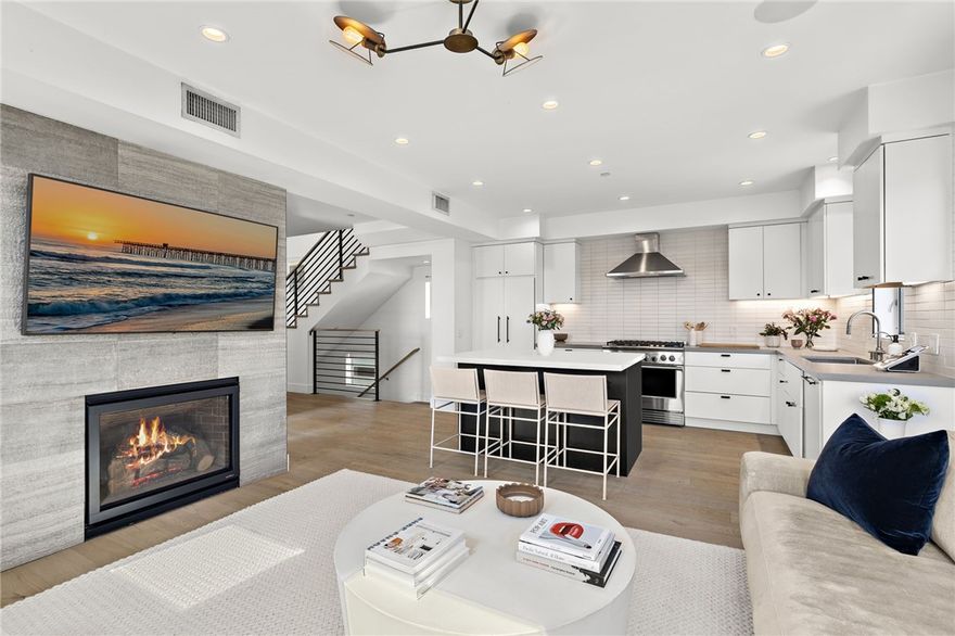 Experience laid-back luxury in this modern coastal residence originally crafted by SAILHOUSE in 2020. Where clean architectural lines meet natural textures, this home embodies timeless design and sophisticated comfort with close proximity to the sand. Featuring 3 bedrooms, 2 bathrooms, and approximately 1,390 square feet of interior living space, this thoughtfully designed home extends upward to an expansive private rooftop deck with panoramic ocean and mountain views. A perfect setting to relax or entertain. Inside, every detail reflects quality craftsmanship: Pental Quartz countertops, European oak wide-plank flooring, European-style cabinetry, and Fisher & Paykel professional-grade appliances. The spa-inspired primary suite showcases matte black Brizo and Kohler fixtures, along with custom tile and lighting selections throughout. From the open-concept interior to the inviting rooftop, every space has been designed for effortless indoor-outdoor living. Close proximity to Vacancy Coffee, il Barone Ristorante, and of course the surf and sand, this home captures the best of urban-coastal convenience in one of West Newport’s most coveted locations of Newport Shores.