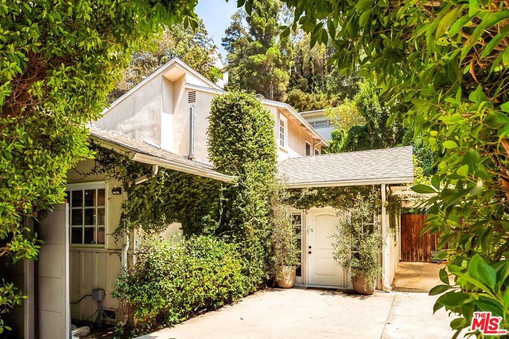 Enter through the gates of this 3 bedroom, 2 bath + den bringing the Canyon magic! Nestled in the beautiful Laurel Canyon and the famed Wonderland School district, the open-concept home is ideal for indoor-outdoor living. The thoughtful floor plan seamlessly connects the kitchen, living, and dining rooms towards the back patio and an expansive flat private green space bordered by fruit trees. The yard is tranquil, dreamy and relaxing. Other wins include flat off-street parking for three cars, and a contemporary kitchen that is outfitted with stainless steel appliances, shaker cabinetry, and a two-tone quartz center island with eat-in seating. A lovely den, used as a playroom by the current owners, rounds out two bedrooms and one bathroom on the ground floor. There's plenty of room to play and relax here. Head upstairs to a primary suite with a walk-in closet, soaking tub, and private balcony overlooking tree-top views. Come experience the magic of this Canyon retreat!