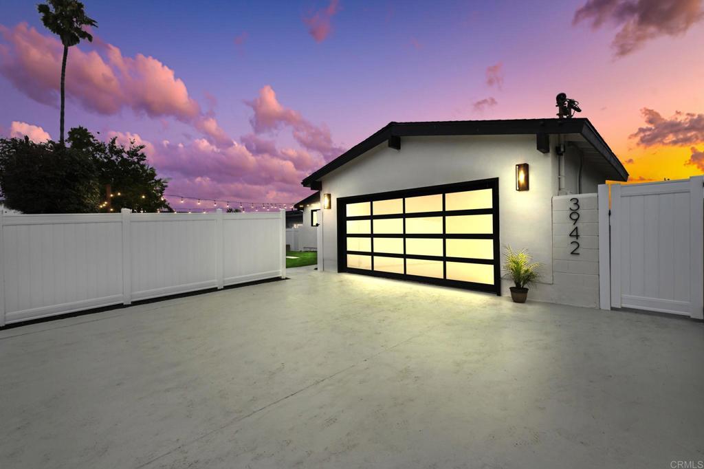 This fully remodeled home in the heart of San Diego blends modern style with inviting warmth. This home exudes curb appeal with new white vinyl fencing, a sleek architectural garage door, and a welcoming courtyard complete with firepit seating, market lights, and new landscaping—perfect for gathering with friends. Step inside to a top-to-bottom transformation featuring new LVP flooring, baseboards, doors, and black-framed windows that fill the open living space with light. Fresh paint inside and out, modern ceiling fans, and thoughtful design touches create a move-in-ready home that feels brand new. The living room flows seamlessly into a stunning chef’s kitchen and dining area, where beautiful light colored cabinetry, a custom tile backsplash, and an oversized waterfall island with bar seating become the centerpiece. Gold accents and new appliances complete the space with a touch of luxury. The private backyard, with fresh drought-resistant landscaping, connects to the front courtyard for a true indoor-outdoor lifestyle. Inside, the spacious primary suite offers an updated ensuite bath with a walk-in waterfall shower. Two additional bedrooms share a remodeled guest bathroom with a tiled shower/tub combo, perfect for family or guests.The large garage with fresh epoxy flooring adds both style and functionality, while major upgrades—including new plumbing and electrical—bring peace of mind. Located just steps from Mount Acadia Park and close to Tecolote Creek trails, schools, shopping, restaurants, and freeway access, this home is as convenient as it is beautiful!