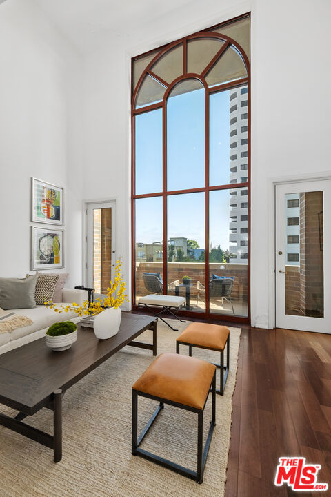 AMAZING OPPORTUNITY! Stunning loft-style New York vibe corner unit with architectural appeal and luxury living at Wilshire Thayer! Contemporary high-volume 2 bedroom, 2.5 bath pied-a-terre, featuring 2-story high ceiling with open-living-dining, gorgeous hardwood floors, dramatic 3-dimensional spiral staircase, soaring floor-to-ceiling Roman-style window, massive wall space for fine art, bold visuals throughout, and enough flex-space for in-home media, a Baby Grand, or other furnishings. This stylish showpiece is bursting with artistic flair - perfect for entertaining! Gourmet kitchen, granite counters, wine fridge, kitchen counter/bar, pantry built-ins and adjacent workspace cater to culinary enthusiasts. Expansive Primary includes floor-to-ceiling closets with built-ins, spacious walk-in with built-ins, dual sinks, large jacuzzi tub, separate shower, separate bidet and commode. Ensuite Second Bedroom (vistas via Roman-style window) can be converted to an artist's retreat or in-home office. Elevator access to both levels, enclosed side-by-side laundry, bonus storage area/closets. 24-hour Doorman, concierge service, switchboard. Fantastic location near UCLA, Cedars-Sinai, Rodeo Drive, Restaurant Row, and Century City's "Destination" Mall. All this, a short drive to Santa Monica, Malibu, and scenic Paradise Cove. Valet entry/exit on Thayer. High-volume flex-space corner units of this architectural caliber are scarce, making this gem a truly gorgeous find -- EXCEPTIONAL VALUE!