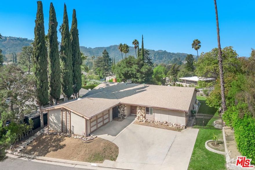 Welcome to this charming Mid-Century Modern home, set on a peaceful street in Studio City's highly sought-after "Donas" neighborhood. This single-story 3BD/4BA residence is in need of some TLC and is ready for its next owner to come in and add their touches. The inviting living room, anchored by a classic stone fireplace, flows seamlessly into the family room, which includes a brick fireplace and a built-in wet bar, perfect for entertaining. The spacious kitchen offers generous counter space, abundant cabinetry, and direct access to an attached two-car garage. Down the hall, the primary suite provides ample closet space and an en-suite bathroom with dual vanities, generous counter space, and a step-in shower. Two additional bedrooms off of the primary share a well-appointed full bathroom with both a soaking tub and shower, while two powder rooms, conveniently located off the kitchen and living room, make hosting effortless. Step through sliding glass doors to a private backyard retreat featuring a charming gazebo and sweeping Valley views. Located within the acclaimed Carpenter Community Charter School District and with easy access via Laurel Canyon to shopping and dining in Hollywood or to scenic trails in the Valley, this residence offers the perfect blend of city living and nature escape.