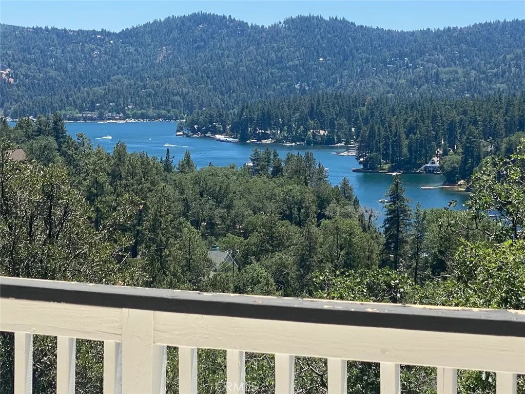 Welcome to 27547 Alpen Drive – A Classic Lake Arrowhead View Charmer with Full Lake Rights! This captivating tri-level mountain retreat offers panoramic Lake & mountain views from nearly every room—including the master suite, guest bedroom, loft, family room, dining area, and even the private balcony of the lower-level unit. Set on a spacious, usable lot with expansion potential, this home is a rare opportunity for full-time living, vacationing, or rental income.
The main residence (Unit A) features 2 ensuite bedrooms, including a primary suite with a jetted tub overlooking the lake, a spacious den (optional 3rd bedroom), full guest bath, a cozy loft with built-in sleeping space, a well-equipped kitchen, and 2 expansive lake-view balconies.
The lower level (Unit B) has its own private entrance, its own Lake view deck and includes a 1-bedroom, 1-bath layout with a full kitchen—ideal for guests or rental income. Both units have separate meters & water heaters.
***The lot offers exceptional value with space to add 2 additional structures or additional parking for boats or vehicles on the lower portion of the property.
Whether you're looking for an investment opportunity or a peaceful escape with unbeatable views, this Lake Arrowhead home is a must-see!