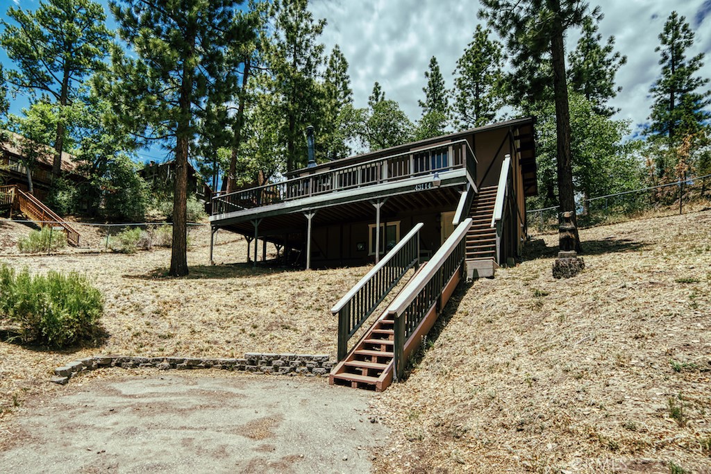Moonridge Chalet with Mountain Charm. This cabin is tastefully decorated to the "T" with all the the cutest mountain decor. Features 2 bedroom and 1 bath upstairs in the main cabin 720 s/f and 1 bedroom 1 bath in the remodeled basement to a fully living 3rd bedroom 2nd bath, done with permits, adding 250 s/f. Laundry closet in the remodeled area including washer dryer stack-able units. Main cabin features vaulted open beam ceiling with and each room having a ceiling fan. Extra large wrap around deck with view of the ski slopes and mountains. Cabin sits back from the road on a 8100 s/f fully fenced lot. Buyer to verify all s/f and permits. Please check out the video walk thru