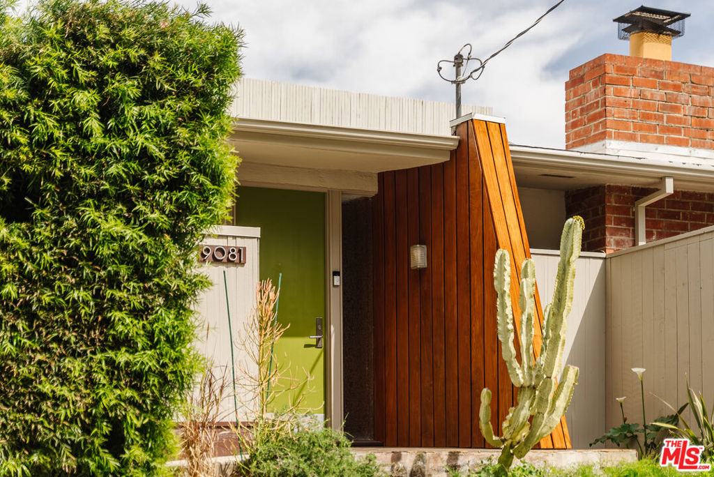 A unique mid-century modern treasure, The Tanner House is perched above scenic Laurel Canyon, blending timeless architecture with a serene natural setting! Designed in 1952 as part of landscape architect Garrett Eckbo's master-planned Beverly Crest community, this flat-roofed masterpiece embodies the era's dedication to clean lines, open-concept living, and seamless indoor-outdoor harmony. A sprawling lot enhances the home's effortless connection to its lush surroundings. Expansive glass walls usher in an abundance of natural light while framing breathtaking treetop views. Inside, warm wood-style flooring and chic tilework contrast elegantly with crisp white interiors, creating a refined yet inviting aesthetic. A striking stacked stone fireplace commands attention in the generous living room, while the adjacent dining alcove extends to a tranquil exterior deck perfect for alfresco entertaining. The kitchen is a dream for any chef, outfitted with stainless steel appliances, handsome cabinetry, and ample prep space. A comfortable family corner offers an intimate retreat, ideal for hosting guests or unwinding after a long day. Three well-proportioned bedrooms are enveloped by your secluded grounds, each with its own peaceful verdant backdrops. The ensuite primary opens to the side garden, creating the feel of a private sanctuary, while the additional chambers overlook the naturally landscaped hillside. Thoughtfully designed baths feature floor-to-ceiling glass walls that blur the line between inside and out. Set in the prestigious Wonderland Avenue School district and near the exclusive Mulholland Tennis Club, this residence enjoys a prime cul-de-sac location with easy access to both Hollywood and Studio City. With a two-car port and a setting rich in architectural history, this is a rare opportunity to own a true mid-century icon. Unveil this stunning gem's many facets for yourself!