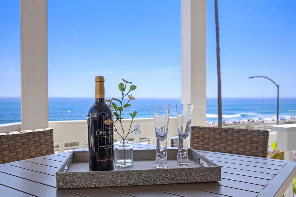 Wake up to the sound of waves crashing and end each day with sweeping sunsets over the Pacific, overlooking iconic Tamarack Beach. Rarely does a home this close to the sand, with views this dramatic—and zero stairs—become available. This meticulously upgraded single-level residence blends refined coastal style with effortless comfort and uninterrupted ocean views throughout.The open-concept floor plan is drenched in natural light from expansive west-facing windows, creating a bright, airy ambiance. The gourmet kitchen features sleek custom cabinetry, modern appliances, and elegant quartz countertops—perfectly designed for entertaining and everyday living. Luxury tile flooring, stylish new bathrooms, and elevated designer touches throughout make this home truly turnkey—just bring your toothbrush. The primary suite is a tranquil retreat offering breathtaking, lie-down ocean views, a spa-inspired ensuite with a separate shower and tub, and sophisticated finishes. A second bedroom and well-appointed guest bath complete this perfectly located coastal haven. Step outside to your private ocean-view patio—ideal for morning coffee or sunset cocktails, all set to the soothing soundtrack of the crashing waves. Live the Carlsbad dream, just moments from Carlsbad Village and world-class dining. This residence offers the best of coastal living with peace, privacy, and postcard-perfect views from both the living room and primary suite —homes of this caliber and location rarely come to market. 2 Dedicated parking spots in the gated garage, private storage room for all your beach accessories, as well as an elevator from the garage to your floor.