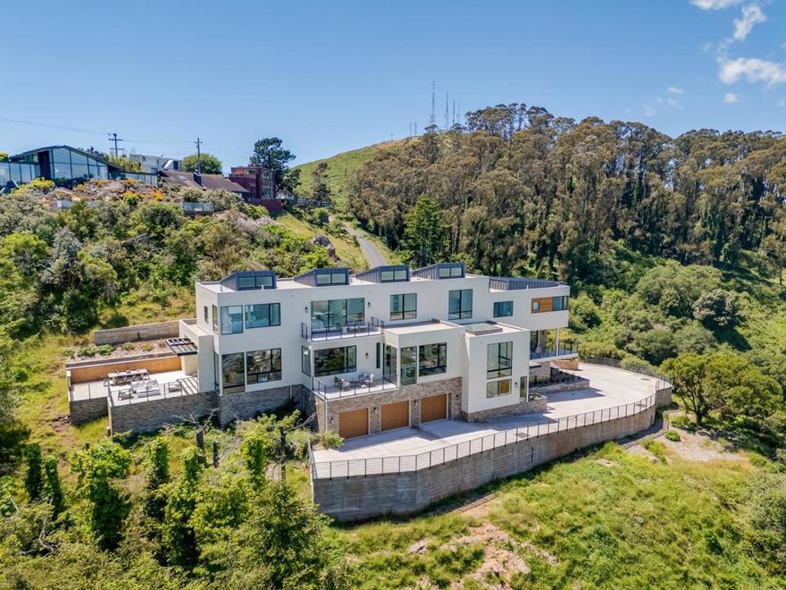 Experience Unparalleled Luxury in the Heart of Sausalito. Step into refined elegance with this newly constructed architectural masterpiece, perched above Sausalito and capturing sweeping, unobstructed views of Richardson Bay, Belvedere Island, Angel Island, and Mt. Tamalpais. This expansive estate offers 5 spacious bedrooms and 5.5 luxurious bathrooms, designed for both grand entertaining and relaxed everyday living. The open-concept layout is filled with natural light, showcasing wide-plank hardwood floors and seamless indoor-outdoor flow. At the heart of the home lies a gourmet chefs kitchen with premium appliances, designer finishes, and two oversized walk-in pantriesperfect for culinary creativity. Wine lovers will appreciate the temperature-controlled cellar with room for 1,000+ bottles. Behind your private gated entrance, enjoy parking for up to 20 vehicles, including a 3-car garage. The expansive grounds offer space for a custom infinity pool, detached studio, or accessory dwelling unit (ADU). Minutes from the Golden Gate Bridge, top yacht clubs, golf courses, and downtown Sausalito, this property blends world-class design with the best of Northern California living.