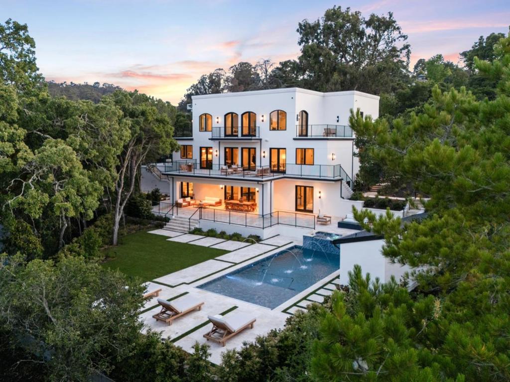 Welcome to Casa La Cumbre, a warm & sophisticated modern home that is just as grand as it is inviting and laid back. Designed & re-built by renowned Bay Area builder, Craftsmen's Guild. At 7,789 sqft, this estate sits on a generous .75 acre lot. The home offers 8 bedrooms, 7.5 bathrooms, formal living & dining rooms, a great room with eat in kitchen, an upstairs den, movie theater, wine room, game room w/ bar and separate au pair quarter that doubles as a home gym. The entire property is integrated with Control4 home automation, allowing you to manage nearly every amenity right from your phone. For added convenience, all three levels are connected via elevator, ensuring effortless access. The heated pool is a standout feature, boasting a jetted jacuzzi, in-ground water spouts, and a sun deck. At the front, automatic gates open to a circular driveway, providing ample parking for visitors. Ideally located, Hillsborough offers residents the perfect balance of convenience & accessibility. Just 6.5 miles to SFO, 15 miles to Stanford/Sand Hill Road, and 23 miles to Silicon Valley, it provides a prime spot on the Peninsula. Residents enjoy proximity to the charming Burlingame Ave, prestigious Burlingame Country Club, and access to North Hillsborough School (buyer to verify eligibility).