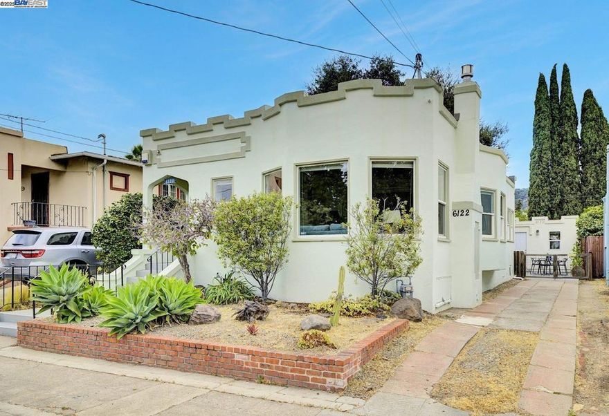 You won’t want to miss this charming 3 bed, 2 bath California bungalow, beautifully updated and full of character. An inviting front porch opens to an elegant entryway, leading into a bright living room with a cozy fireplace, built-ins, and an adjoining spacious dining area. The kitchen has been thoughtfully renovated with quartz countertops, subway tile backsplash, and a breakfast nook that doubles perfectly as a home office. The bedrooms are thoughtfully separated by a beautifully updated bathroom showcasing a stone countertop and classic penny tile flooring. Outside, the expansive backyard is perfect for entertaining and unwinding, complete with a generous deck and pergola, outdoor shower, raised garden bed, and fresh landscaping filled with native plants. A thriving vegetable garden promises a bountiful summer harvest, while a majestic oak tree offers natural shade and timel Additional highlights include a fully permitted ADU, ideal for guests, rental income, or extended family, plus owned solar panels to keep energy costs low. Located in Oakland’s desirable Millsmont/Frick neighborhood, with close proximity to the Laurel District, local hiking trails, and Mills College, this home is the perfect place to put down roots—truly move-in ready and waiting for its next owners.
