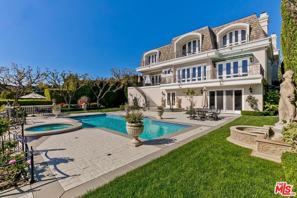 Stately Traditional estate located in the prestigious Bel Air Crest guard-gated community. Grand foyer with stunning new hardwood flooring, light and bright living room with fireplace and formal dining room. Enormous family room with bar, perfect for large gatherings. Updated eat-in kitchen with beautiful island. Private office with bath. Sumptuous primary suite with dual bathrooms and closets. There are an additional 3 bedroom suites that complete the upstairs. Lower level game room & 2 housekeepers rooms, one currently being used as a gym. Resort-style backyard with pool and canyon views. Large garage provides ample parking for approximately 6 to 8 cars and storage. The home has an elevator. Residents enjoy exclusive access to community amenities such as tennis courts, a clubhouse, fitness center, and scenic hiking trails. Just minutes from the heart of Beverly Hills and the Westside. Beautiful living in the heart of the city, offering privacy and security.