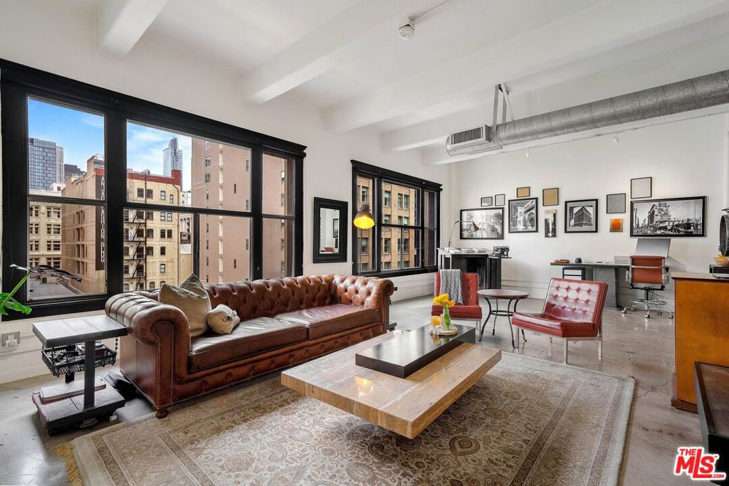 Seize this rare opportunity to occupy an entire floor in the exclusive Tomahawk Lofts, a historic gem nestled in the heart of Downtown L.A.'s vibrant Fashion District. Spanning an expansive 1,820 square feet, this exceptional loft is the ultimate live/work space, designed to inspire creativity. The Tomahawk is unique in so many ways, from the private keyed elevator that opens directly into the residence, ensuring both privacy and convenience to having street to street frontage as the loft stretches from Spring St. to Main St., offering captivating easterly and westerly views through oversized windows that flood the space with natural light and provide excellent cross-ventilation. The flexible open floor plan invites endless customization possibilities, and the high-end Bulthaup kitchen, equipped with Miele appliances, is fit for a chef. Additional features include central HVAC system, an in-unit washer and dryer, 11-foot exposed concrete slab and beam ceilings, custom built-in bookcases, and ample storage. The Tomahawk Lofts, a boutique 8-story Los Angeles Historic-Cultural Monument built in 1914, was one of the pioneers of modern architecture and played a pivotal role in the Flat Iron Park building boom at the intersection of Spring and Main streets. Fully renovated in 2004, the building's plumbing, wiring, and modern safety systems are up to date and meet current building and seismic standards. Secured garage parking is available for an additional fee and is conveniently located adjacent to the building. Located in the heart of the Fashion District, the Tomahawk is steps away from high-end designer boutiques, top-rated restaurants, Whole Foods, the Apple Store, the Flower Market, LA Live, and the best DTLA has to offer. With walking distance to the Arts District, Little Tokyo, and South Park, easy access to freeways and public transportation, this SoHo-style loft is truly one-of-a-kind and an irreplaceable piece of L.A. history. Tenant is responsible for HOA move-in/move-out fees and is required to carry renters insurance.