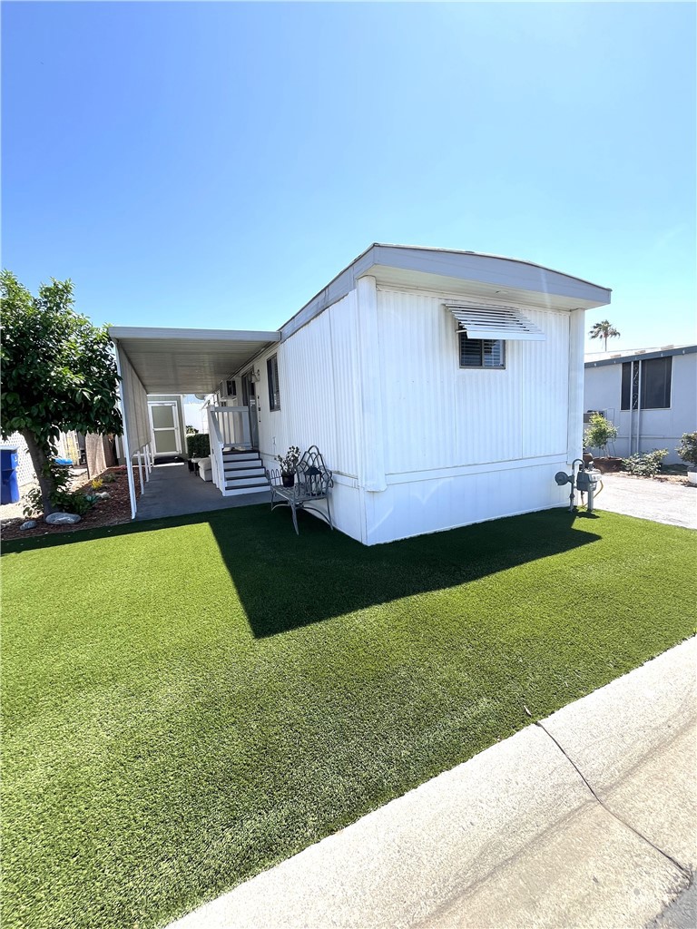 Welcome to Mission Village, a 55+ Community in the city of Riverside. This quaint home with 2 bedrooms and 1 bathroom has a spacious living room that opens to the dining area and kitchen. There is flooring throughout, a glass slider off the living room, window a/c's, and a stackable washer and dryer. If you are looking for a private oasis and tranquility you will find it in the backyard. There is a beautifully designed planter with a grape arbor, and vinyl fencing for privacy, and an area to add outside patio furniture. If you need extra storage you will love the 12 x 15 storage shed that is 2-story with a loft. There is also a Brinks Home Alarm System that can be transferred into the buyers name. This home is perfect, with low-maintenance inside and outside, and living in a quiet community. If you want to entertain on a larger level you are steps away from the newly remodeled clubhouse with a beautiful kitchen, a pool and spa. Don't let this one pass you up.