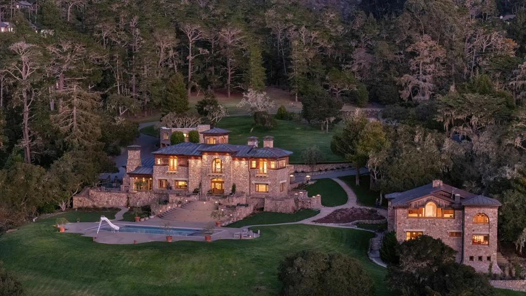 Breathtaking views of the coastline stretching from Point Lobos to sunsets across the Pacific Ocean, this private 14-acre estate in Carmel Highlands has long served as a source of inspiration for Grammy-Award winning composer Alan Silvestri, whose work includes iconic scores for Back to the Future, Forrest Gump & The Avengers. The beautifully reimagined Craftsman-style main residence is distinguished by its architectural character and craftsmanship. Locally sourced jade, stone, & redwood are woven into the design creating a blend of elegance and authenticity. Enjoy the stunning ocean view setting with a swimming pool & hot tub, landscaped grounds & a private tennis court. Also featuring 3 guesthouses, each with its own story to tell, offering versatile spaces for family, guests or creative pursuits. Just a short drive from the charm of Carmel, this extraordinary property combines natural splendor with meticulous design, offering a rare opportunity to experience both inspiration & serenity.