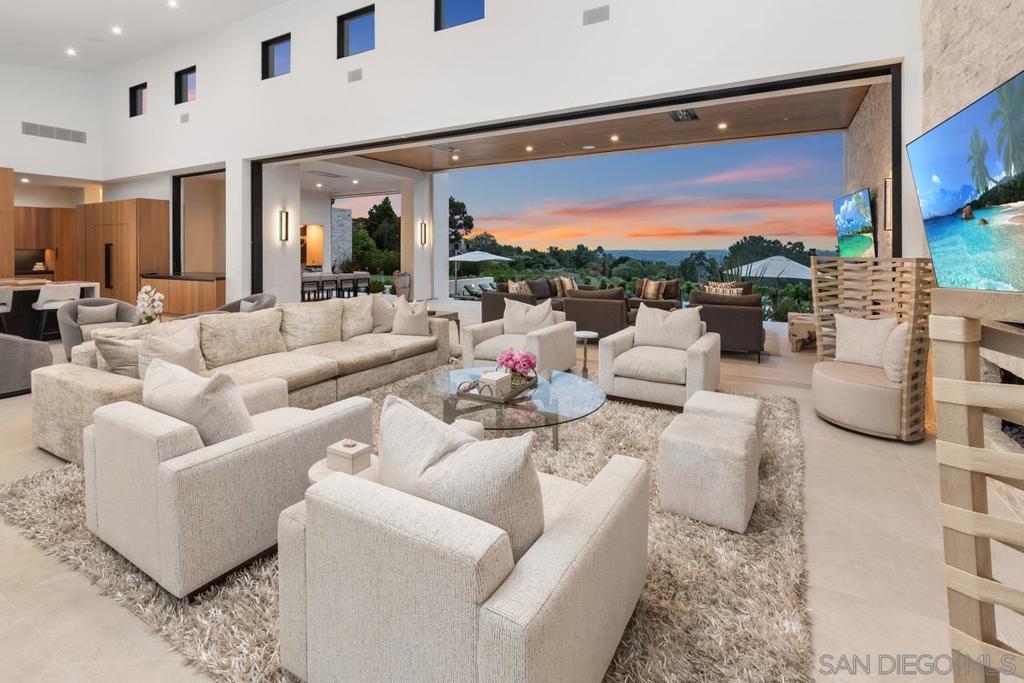 This Custom Estate, 2022, built by Greg Agee is at the highest quality level! Truly a one-of-a-kind property with Panoramic VIEWS! Step onto Italian porcelain floors that flow seamlessly from your floating water entry way to inside to out, and marvel at automated sliding pocket glass doors that flood the space with natural light. The Dorn Bracht kitchen, a chef's dream, boasts Waterworks finishes, luxury top end appliances, Cristallo countertops, and a dazzling backlit backsplash. Each bedroom is an ensuite, ensuring privacy and comfort, while smart home features including Lutron lighting, Sonos Surround Sound, and Nest Thermostats in the palm of your hand to always set the stage for the perfect ambiance. The primary suite, a haven of luxury and tranquility, features Duchateau herringbone flooring, cozy fireplace, automated shades, and amazing VIEWS. Spa-like bath retreat with lavish finishes and fixtures. Outside, explore your private oasis and enjoy a serene a floating edge pool, putting green, sunken firepit, turf soccer field, batting cage and 60-year-old olive trees. 2 bedroom-detached guest house with full kitchen, laundry and living room for your overnight guests. With advanced security, SOLAR, whole house filtration, softener and backup generator, this home combines sophistication and practicality, offering an unparalleled lifestyle.