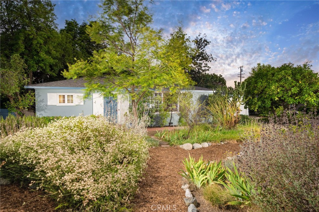 Claremont Village Single Story with Guest House! Located in the heart of the coveted Claremont Village, this single-story home offers a rare blend of classic design and modern functionality, just moments from the shops, restaurants, and colleges that define the neighborhood. The front yard is thoughtfully landscaped with mature citrus trees, agave plants, and lush greenery that add to the home’s curb appeal. A new roof was installed in 2020, and a 200 amp electrical panel was installed in 2008. Inside, hardwood floors run throughout the main living areas, creating warmth and continuity. The layout begins with a spacious living and dining area, anchored by a wood-burning fireplace and large windows that frame peaceful outdoor views. Built-in features add both function and charm to this open-concept space. The kitchen is expansive, featuring rich wood cabinetry, tiled countertops, a built-in electric cooktop, a brand new dishwasher, and a breakfast nook ideal for casual meals or morning coffee. Adjacent to the kitchen, the family room is filled with natural light, thanks to its generous windows and seamless indoor-outdoor flow, with space for an additional dining area. The home includes three well-appointed bedrooms and two bathrooms. The primary suite stands out with a walk-in closet, dedicated vanity space, and direct access to the backyard, offering retreat-like comfort. Beyond the main house, a detached studio ADU adds to the overall convenience. Offering incredible flexibility, the studio is complete with its own kitchen and private bathroom. This additional space is ideal for hosting guests, accommodating extended family, or fostering creative pursuits. Outside, the property continues to impress with a spacious deck ideal for lounging, dining, or entertaining. Mature trees and lush greenery surround the space, offering both privacy and a serene backdrop. An outdoor brick fireplace and built-in bar enhance the atmosphere, creating a space that’s both functional and inviting. With plenty of room for future customization, whether you envision a garden, outdoor kitchen, or play area, this backyard is designed to evolve with your lifestyle while maintaining its charm and prime location.