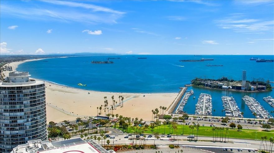 Breathtaking open air ocean Views of the beautiful Pacific Ocean! This beautiful condo has 10-Foot High Ceilings with beautiful hardwoods in the living room and both bedrooms. Slate tile in the kitchen, Both bedrooms offer walk-in closets, and the main room has suite bathroom. The kitchen boasts Granite Counter- Tops & all appliances including an in-unit Laundry Room w/full size washer/Dryer. For Your Comfort there is Central AC & Heating. Stunning Views from living room and bedrooms, 2 Private Balconies Secure Gated I Assigned Parking Space in the underground garage. HOA monthly fees includes Water, 24/7 Security Concierge, Fitness Center & Sauna, club Room with & Business Centers high speed internet through Frontier. Enjoy the short distance to the beach, miles of biking trails, the metro lines, local restaurants and shops. Night life & entertainment venues including the Terrace Theater with the dancing fountains. the Pike. the cinema. Hast Village and so much more!