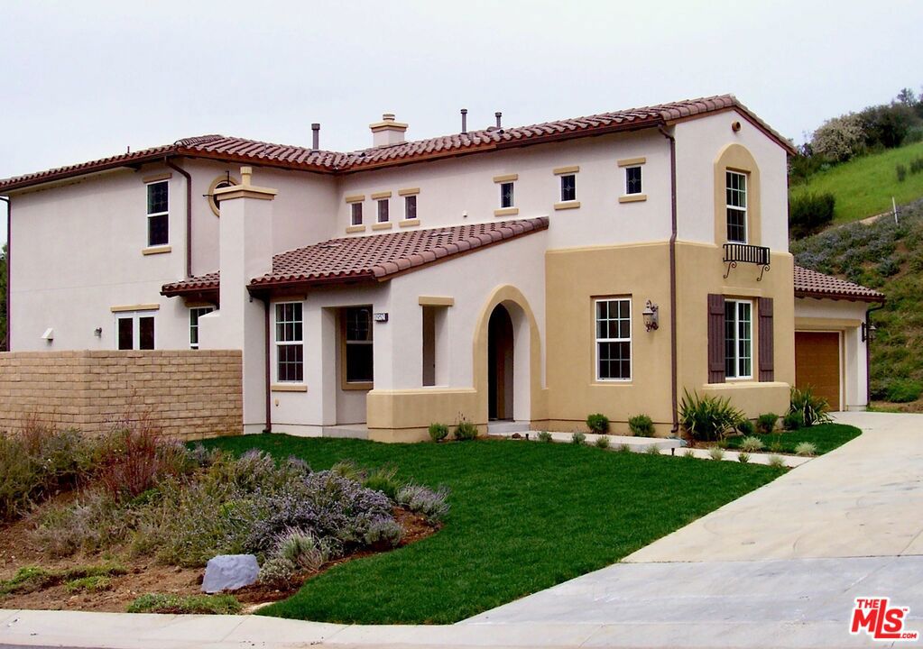 Discover this beautiful Spanish-style home on a corner lot in the coveted Malibu Canyon area of Agoura Hills. This stunning 4-Bedroom (plus a convertible office/5th bedroom), 5-Bathroom residence is perfectly located, just minutes from the beaches of Malibu, the rustic charm of The Old Place and The Road Store, and downtown Agoura Hills. The home's authentic Spanish aesthetic is enhanced inside with rich, dark Eucalyptus Hardwood and elegant Tumbled Travertine flooring, and features a custom Wrought Iron and Wood staircase. The upgraded kitchen is a chef's delight with a Wolf range/oven and wine refrigerator. Complete with an upstairs recreation room/media center, custom closet built-ins, and a four-car tandem garage, this is the perfect family home. Step out to the spacious backyard, ready for your family to take in gorgeous canyon sunsets. More photos to come.