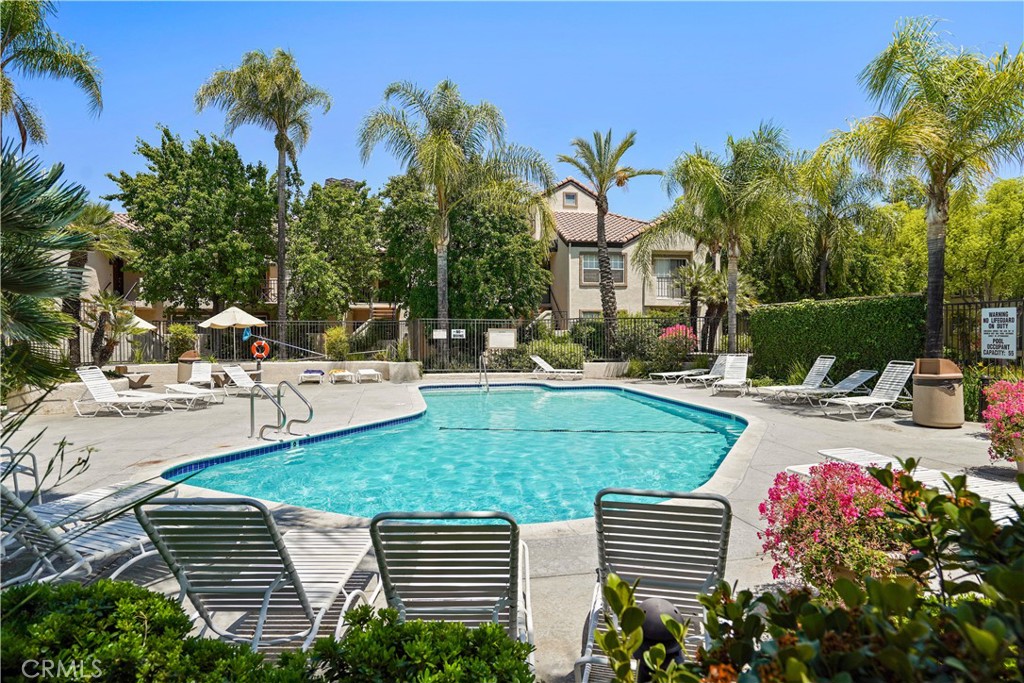 Location! Location! Location! Resort style living in the heart of Valencia at the highly desirable Siena Villas! This rare, move-in ready light and bright upper level open concept 1 bedroom, 1 bath + loft (could be 2nd bedroom, office, or gym) 835 sq.ft. condo is in close proximity to Valencia Town Center Mall, restaurants, shopping, walking / biking paseos, parks, trails , Whole Foods, Starbucks, CAL Arts, COC, and easy freeway access. A bricked tile entryway opens to the living room is flooded with natural light, has smooth cathedral ceilings, a corner fireplace with bricked tile border, a sliding glass door leading to the balcony, and has a staircase leading to the loft with a closet. The dining area opens to the living room and kitchen which includes newer stainless steel appliances, including a refrigerator, and a breakfast bar counter for additional seating. The large bedroom has extra storage area a sliding glass door to the balcony, and a walk in closet. The bathroom has been updated with a tub / shower, dual sinks, indoor laundry closet with stackable washer and dryer included. The balcony can be accessed by the living room and bedroom and has views of trees. Additional amenities include - 2 tandem car spaces in gated subterranean parking, custom paint, newer A/C & heater, and newer water heater. The HOA amenities include multiple pools & spa, tennis courts, car wash area, trash, water, grounds keeping, and has an abundance of guests parking! This home is absolutely stunning and shows true pride of ownership and has award winning schools!!!