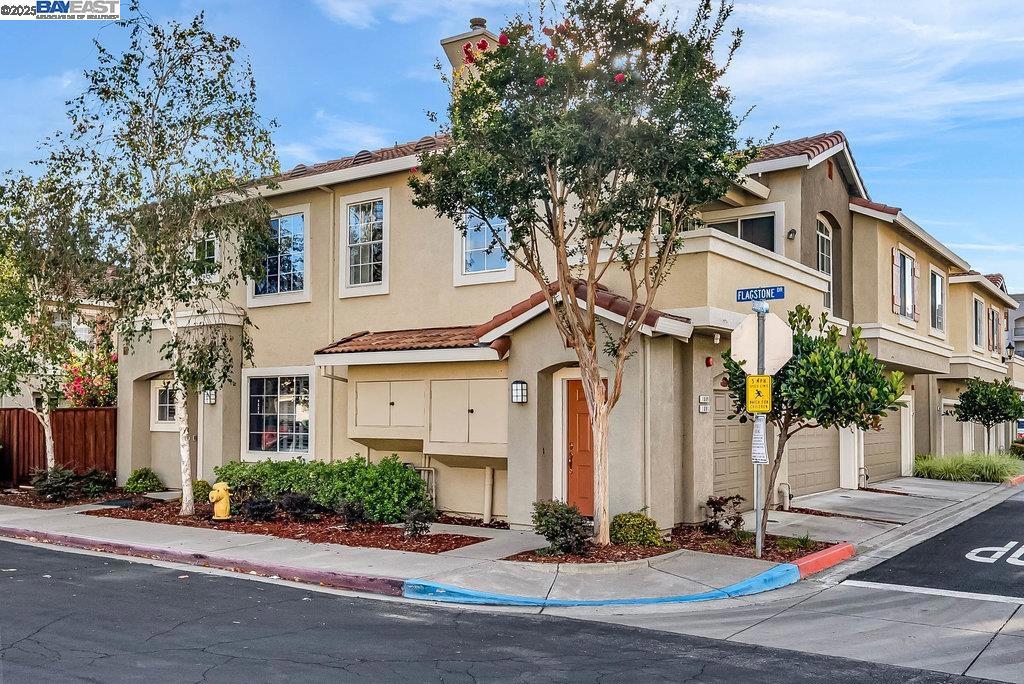 Welcome to this fantastic townhouse in Union City’s sought-after Brookstone community, offering gorgeous views of the hills. Situated on a desirable corner location, this townhouse is filled with natural light and features an open living room with a built-in entertainment niche and a tile-faced fireplace. The dining area highlights a decorative chandelier and sliding patio door leading to the balcony. The spacious kitchen boasts granite countertops, matching trim, freshly painted white cabinetry, stainless steel appliances, and recessed lighting. The primary suite offers laminate flooring, a walk-in closet, and ample space, while the updated primary bath includes double vanities, an updated stall shower, and a privacy split bath. The hall bath offers an large vanity and a shower over the tub. Additional features include: laminate flooring throughout, fresh new int. paint, dual-pane windows, central heat and AC, inside laundry room, relaxing balcony and a 1-car attached garage w/extra storage space. Enjoy the community park and playground just steps away. Commuter-friendly location close to Union City BART, Hwy 880, shopping, schools, and regional parks. Don’t miss this opportunity! Open house Sat 9/20 & sun 9/21 from 1:00-4:00 pm.