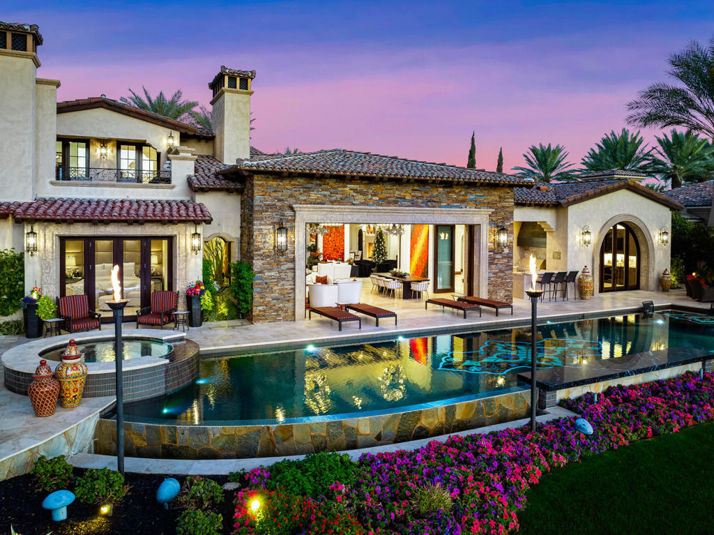 Over $3 million in updates and upgrades have been made since the seller purchased this home! Location, location, location! Jaw dropping VIEWS from this magnificent custom estate home, located in the Hideaway Golf Club on the 7th signature hole of the Clive Clark course. No expense was spared and no detail overlooked when this home was constructed and recently updated. You enter through a gated courtyard into a grand great room with pocket doors, a wet bar and an impressive gourmet kitchen with top-of-the-line appliances. There are 6 bedrooms (including guest casita) 7.5 bathrooms and a total of 5 fireplaces in an imposing 7,810 SF. This home also offers an office with a balcony featuring a fireplace and panoramic Western golf course and mountain views. The outdoor patio area is an entertainer's dream with an inlaid mosaic tile pool, waterfalls, a sunken firepit, built in BBQ, misters and more! Recent major updates make this property exceptional. This estate is a rare find and the quintessential desert paradise! Offered furnished.