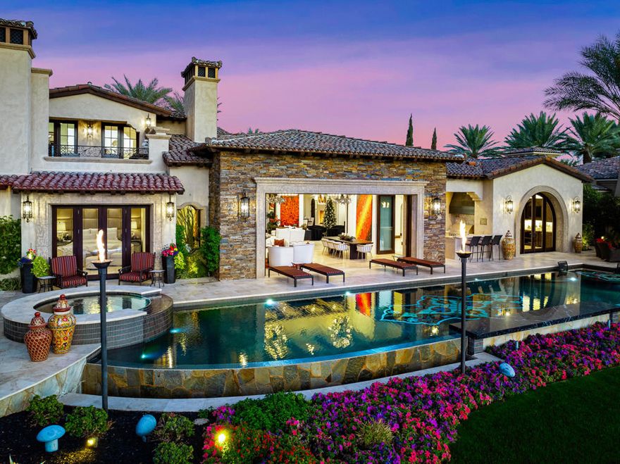 Over $3 million in updates and upgrades have been made since the seller purchased this home! Location, location, location!  Jaw dropping VIEWS from this magnificent custom estate home, located in the Hideaway Golf Club on the 7th signature hole of the Clive Clark course.  No expense was spared and no detail overlooked when this home was constructed and recently updated.  You enter through a gated courtyard into a grand great room with pocket doors, a wet bar and an impressive gourmet kitchen with top-of-the-line appliances.  There are 6 bedrooms (including guest casita) 7.5 bathrooms and a total of 5 fireplaces in an imposing 7,810 SF.  This home also offers an office with a balcony featuring a fireplace and panoramic Western golf course and mountain views.  The outdoor patio area is an entertainer's dream with an inlaid mosaic tile pool, waterfalls, a sunken firepit, built in BBQ, misters and more!  Recent major updates make this property exceptional.  This estate is a rare find and the quintessential desert paradise!  Offered furnished.