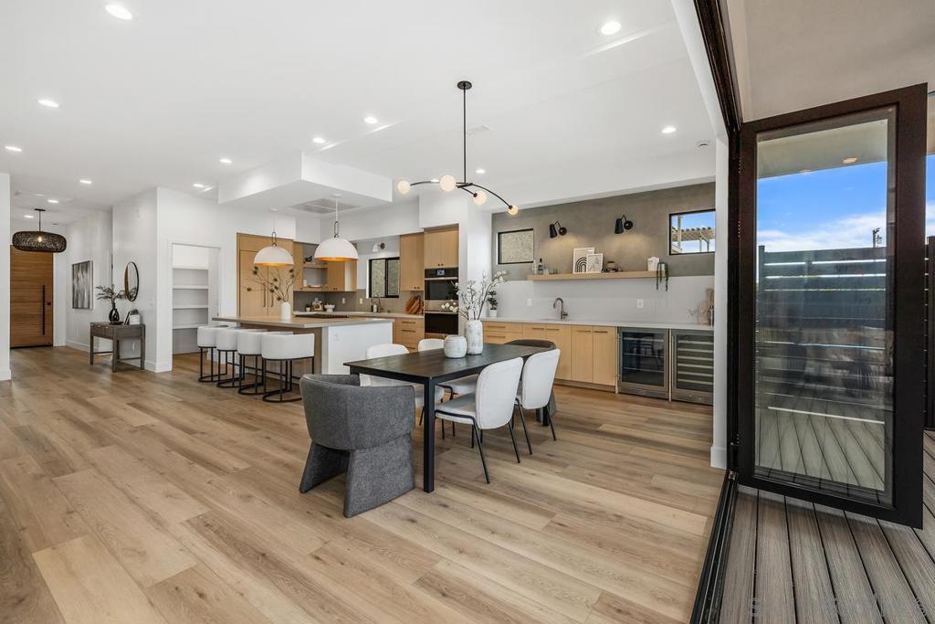 Brand-New Permitted Remodel on a 7,300 sq. ft. lot blends Scandinavian-inspired design with luxurious finishes for a serene, sophisticated living space. Enjoy breathtaking 360° views—including SeaWorld fireworks and bay vistas—from two second-floor decks and a rooftop. The open-concept kitchen and living room flow seamlessly to the backyard through bi-fold doors, perfect for indoor-outdoor living. Highlights include champagne brass fixtures, custom white oak cabinetry, a built-in bar, and a striking Venetian plaster fireplace. Natural light floods the home, accentuating clean lines and calming wood-and-white tones. The primary suite features a spa-like bath with terrazzo floors and lime plaster walls. Includes solar, EV charger, and $25,000 SELLER CREDIT TOWARD LANDSCAPING TO CUSTOMIZE YOUR OUTDOOR SPACE.