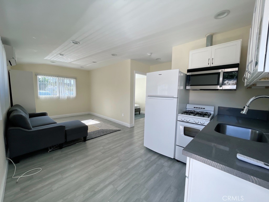Welcome to comfortable and convenient living in this charming remodeled ADU nestled in the desirable neighborhood of Carlton Terrace. This delightful unit has bright natural lighting and is accessed via its own private entrance. The open-concept kitchen flows into the living area with included amenities such as a refrigerator, gas stove, and the very convenient feature of an in-unit washer and dryer. And don't forget to ask about the available optional furnishings at no charge! Great shopping and dining scene nearby along Ventura Boulevard as well as the Village and Topanga Westfield Malls. Commuting is a breeze with easy access to the 101 freeway and public transportation. As far as utilities, trash service is included in rent and gas and water are added to monthly rent for a flat fee (ask agent for amount). Power/electricity is paid by the tenant. Unit was a garage prior to conversion to an ADU and shares a common wall with its attached sister house. Street parking is available. All in all, this is a super cute and easily maintainable unit with easy in and out access close to pretty much everything you need. Landlord seeks financially qualified applicants; strong credit history preferred. Scheduling a showing today! It's easy, just call the listing agent.